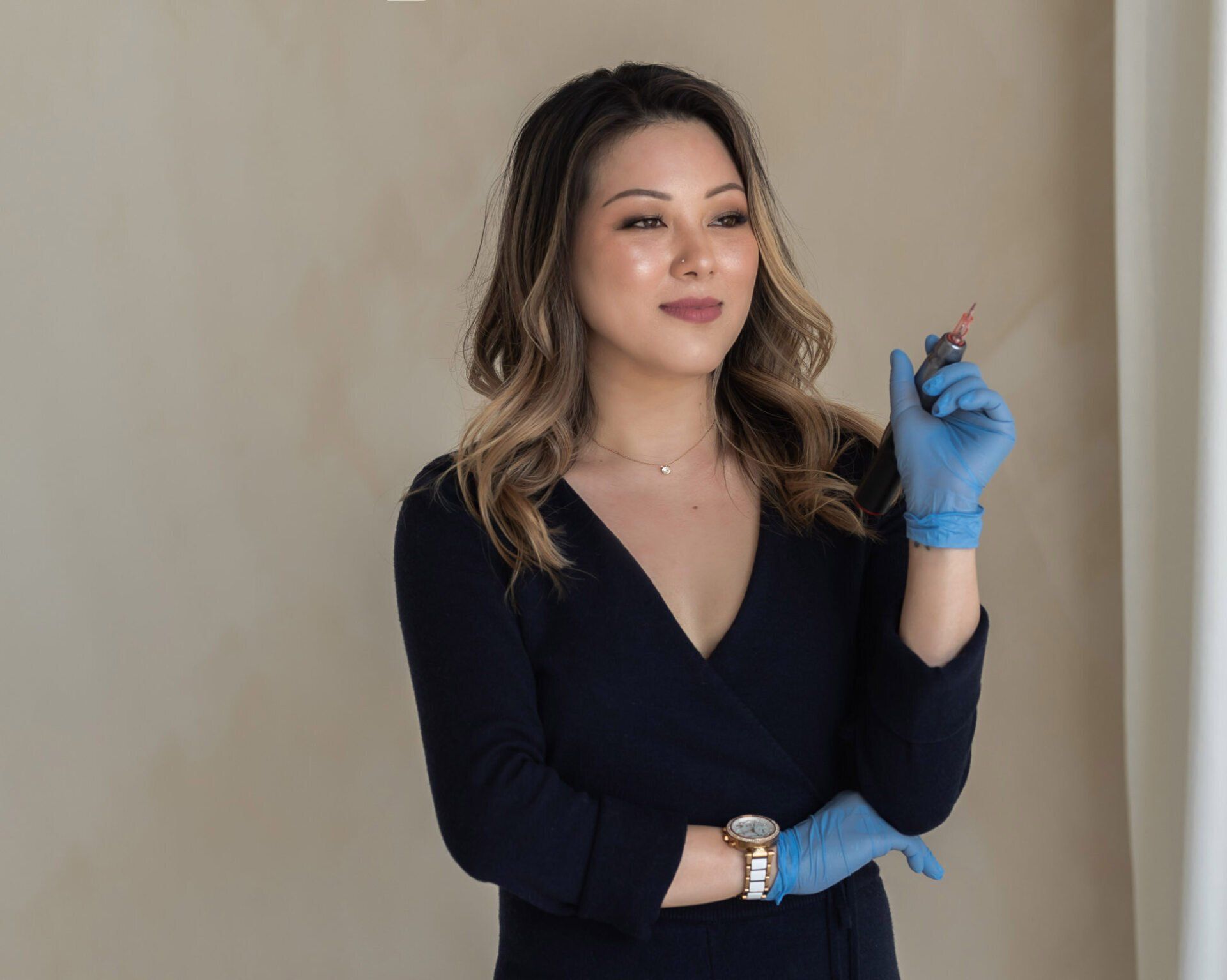 Beauty spa own wearing surgical gloves and holding a syringe