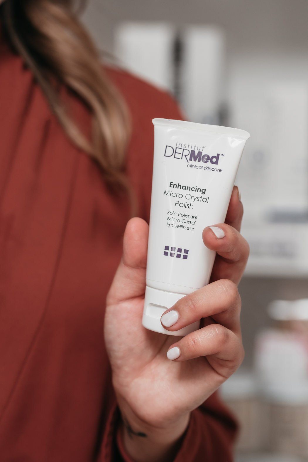 Spa staff member presents a beauty product