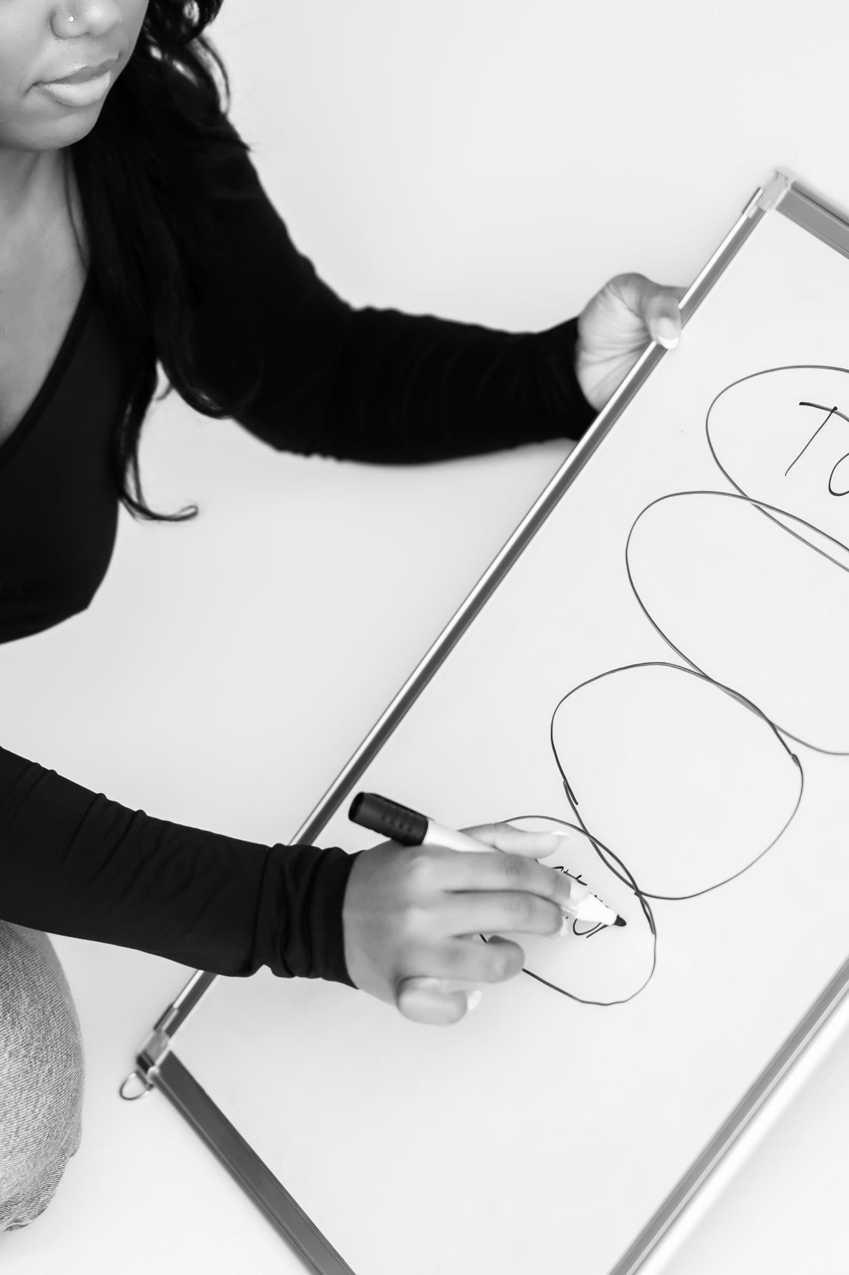 A focused professional outlines a strategy on a whiteboard, capturing the essence of expertise and strategic planning in marketing.