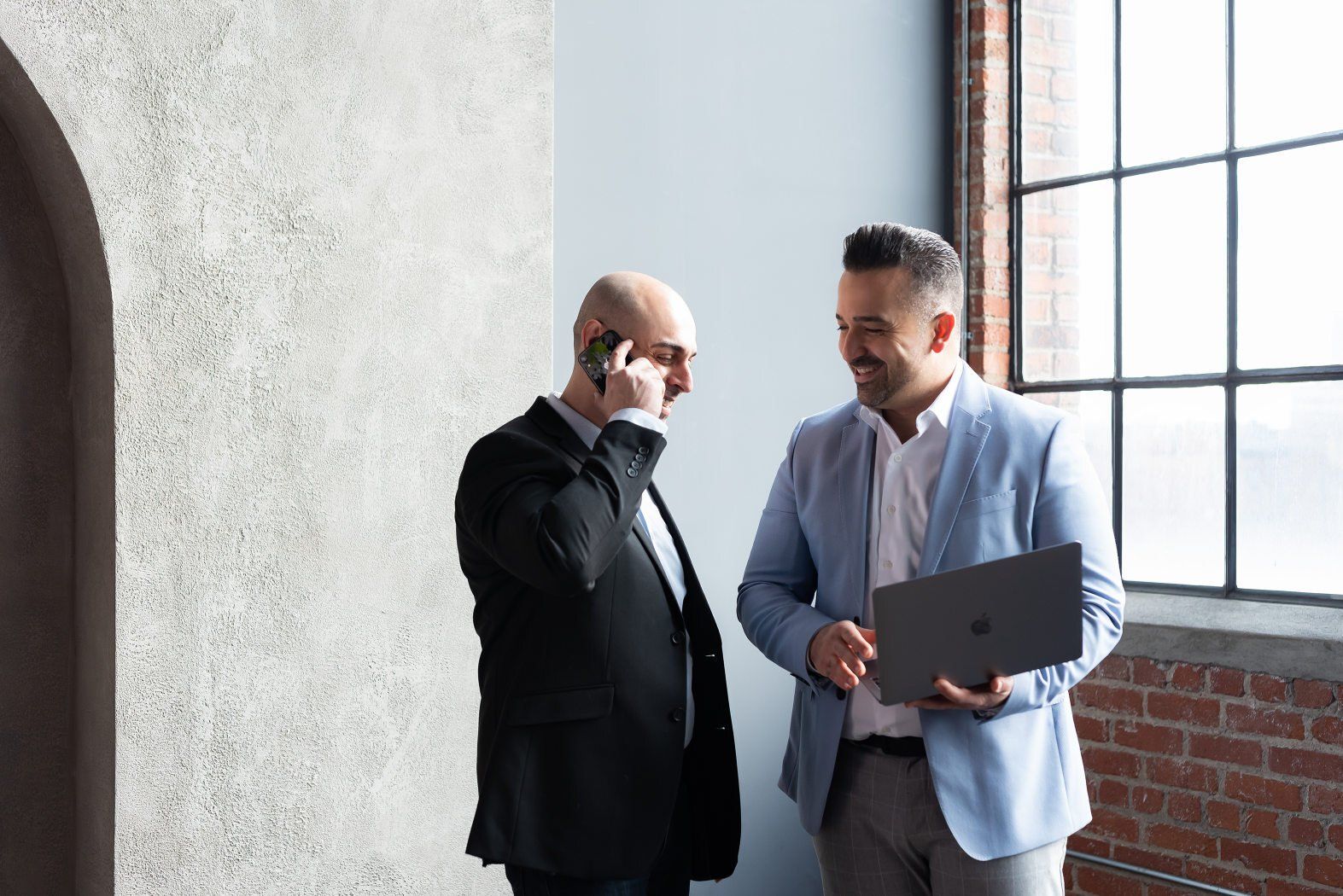 a candid shot of two realtors near a window