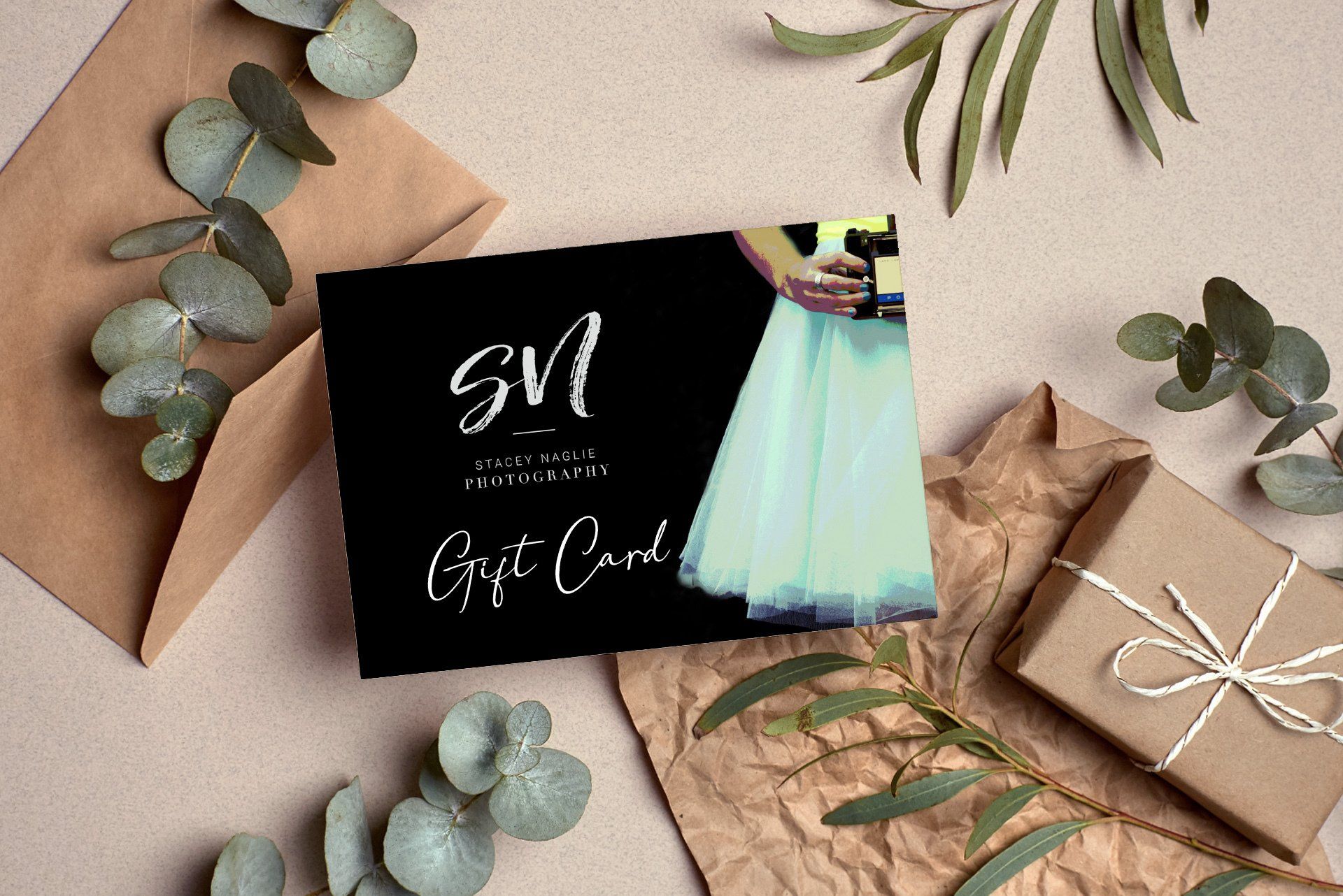 A Stacey Naglie Gift Card situated with gifting materials and plants