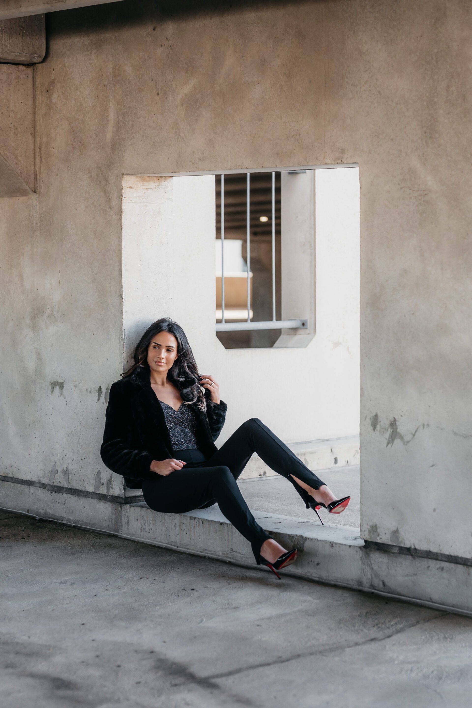 Social influencer Chantel in a casual black outfit posing in a concrete background