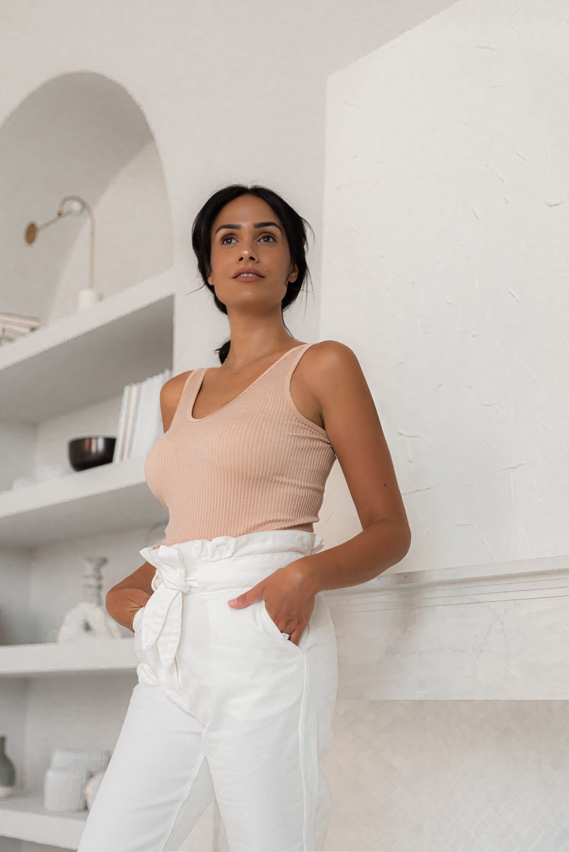 Social influencer Chantel in a beige top and white pants