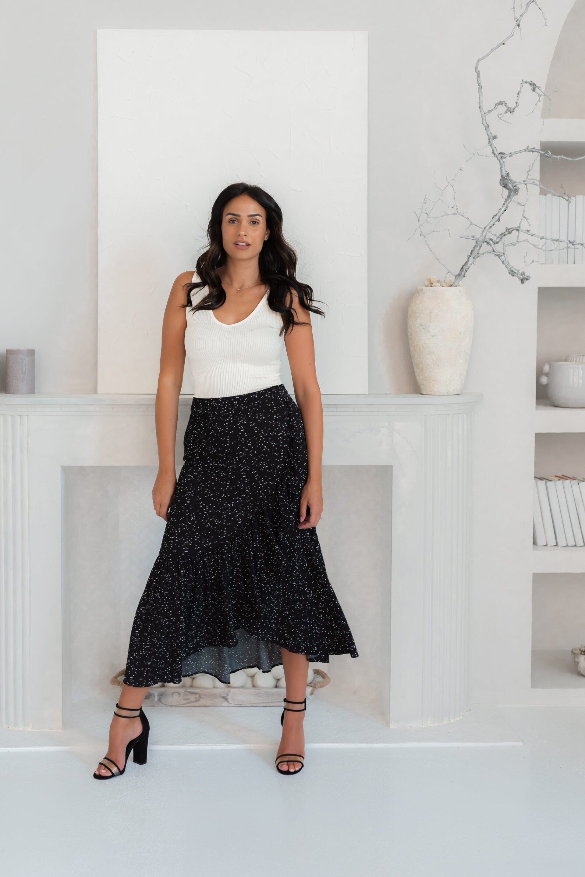 Fashion influencer Chantel wearing a white top and long black skirt