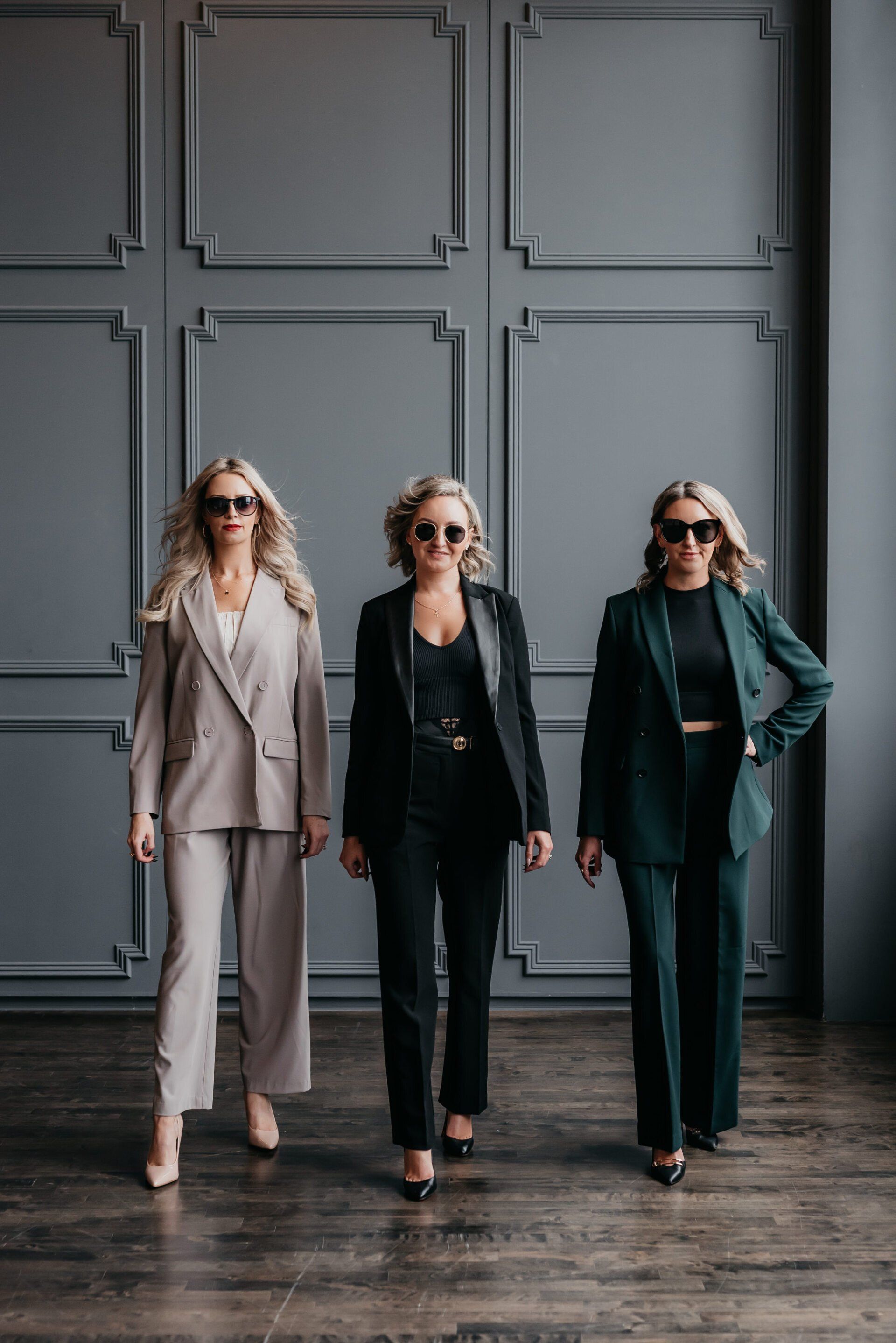 Group portrait of realtors with a dark wall background professionally taken