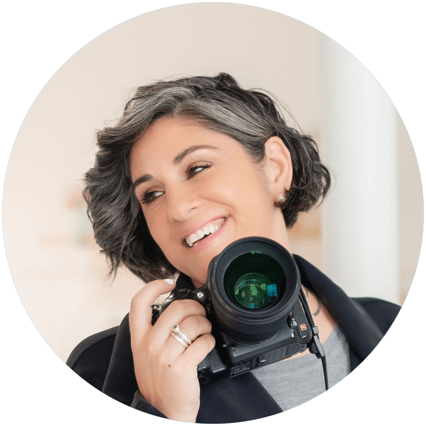 Stacey Naglie smiling while holding a camera