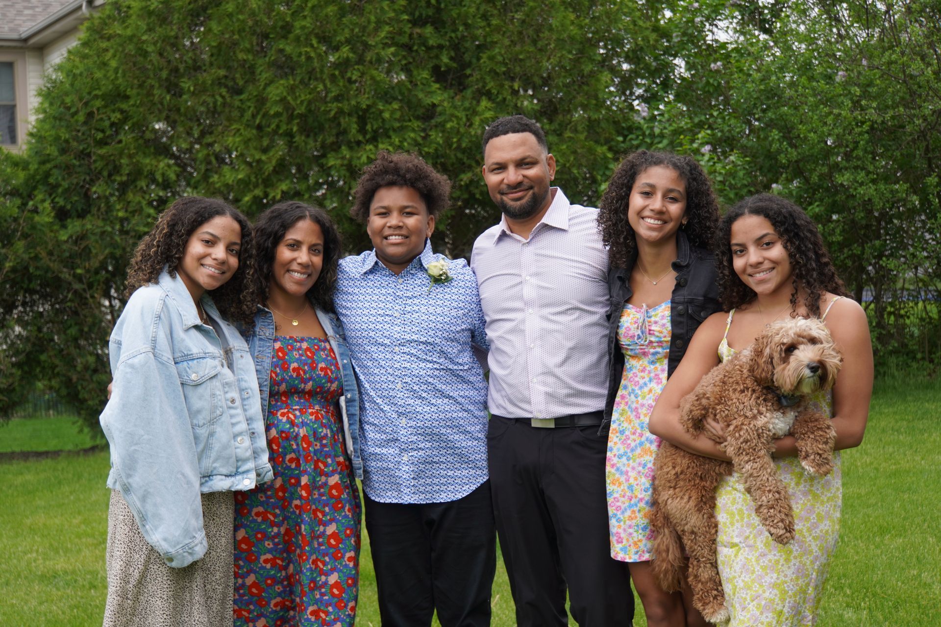 beau mitcham and his family posing for a picture with a dog.