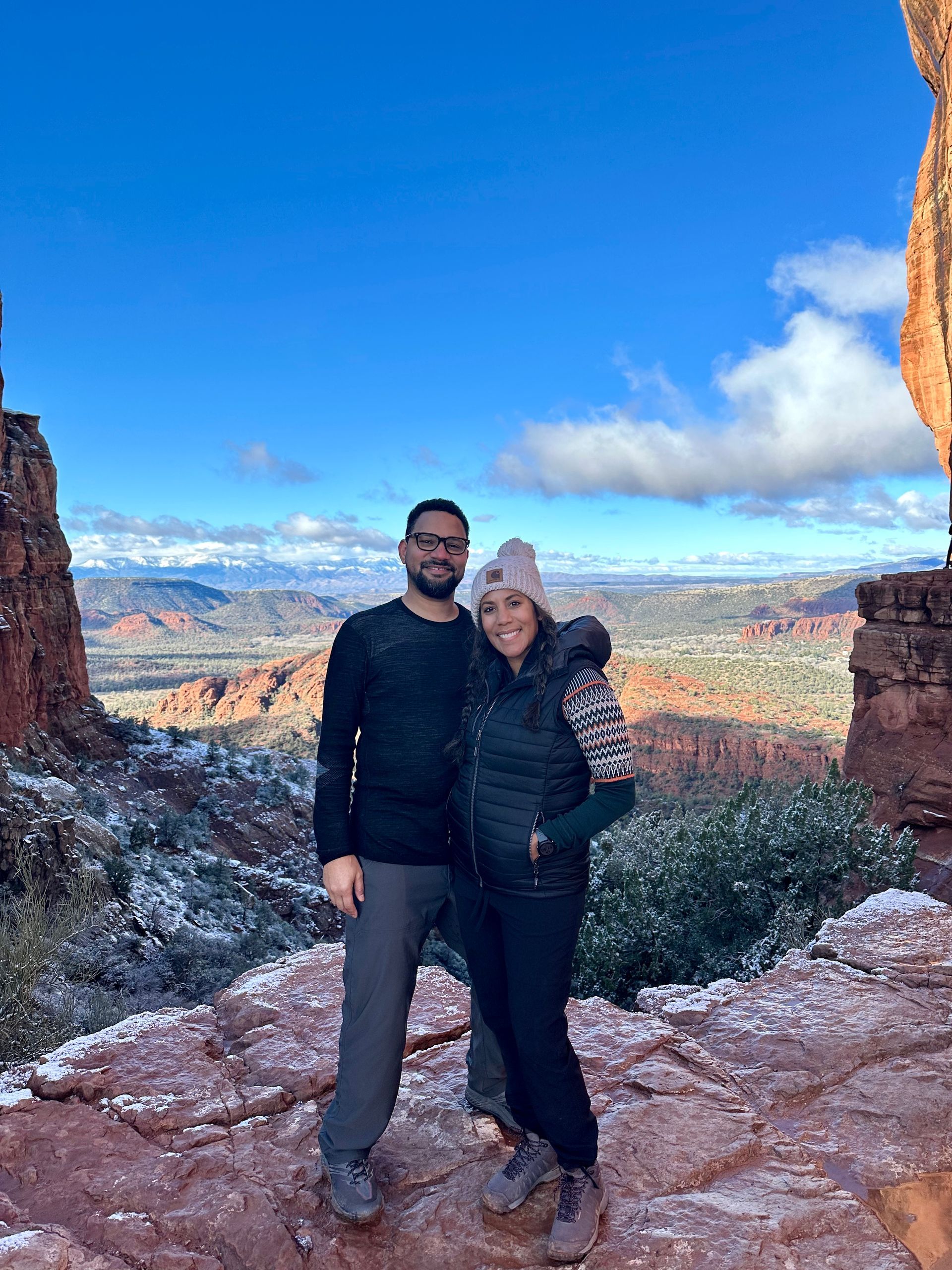 beau mitcham and a woman are posing for a picture on top of a mountain.