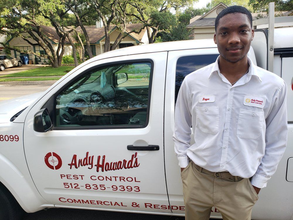 A man is standing in front of a white truck.