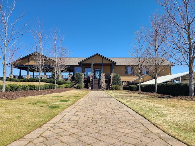 a large house at Kaya Vineyards with a brick walkway leading to it.