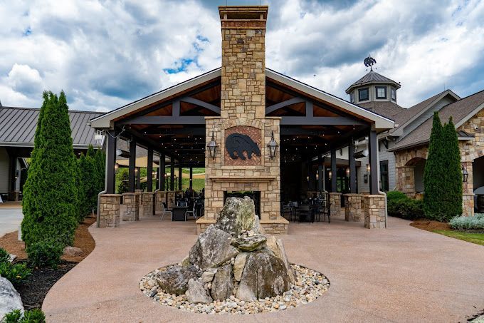 a large stone fireplace is in front of a large building .