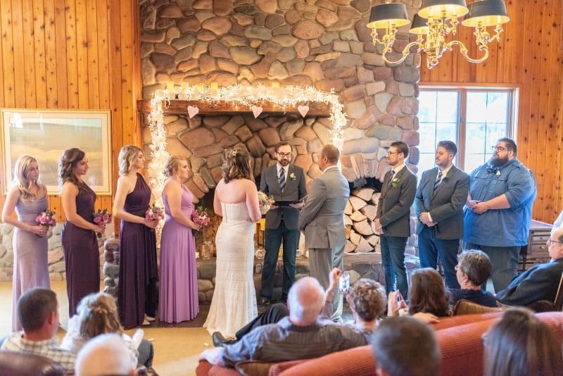 A bride and groom are getting married in front of a crowd of people.