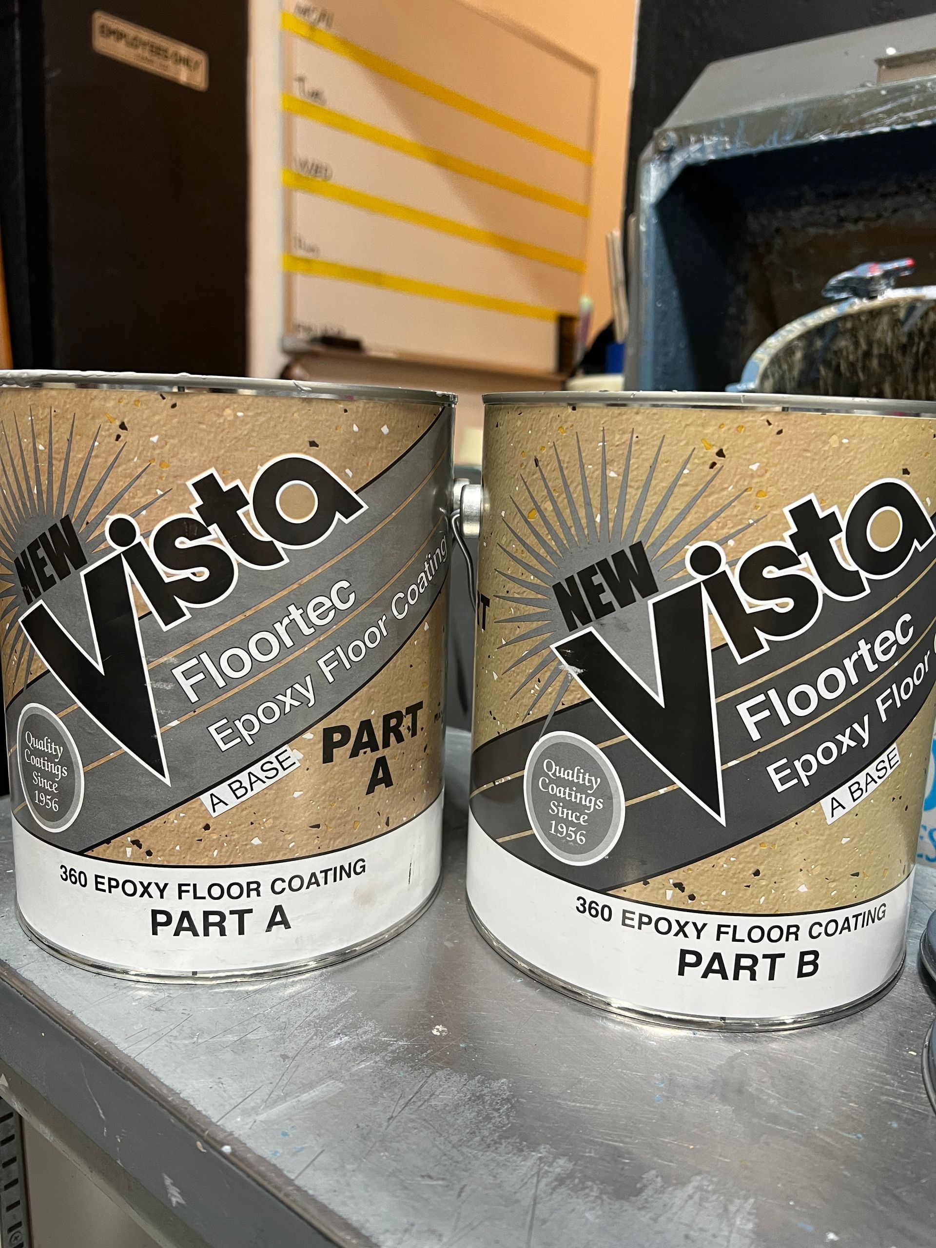 Two Vista FloorTite epoxy resin cans labeled Part A and Part B on a shelf