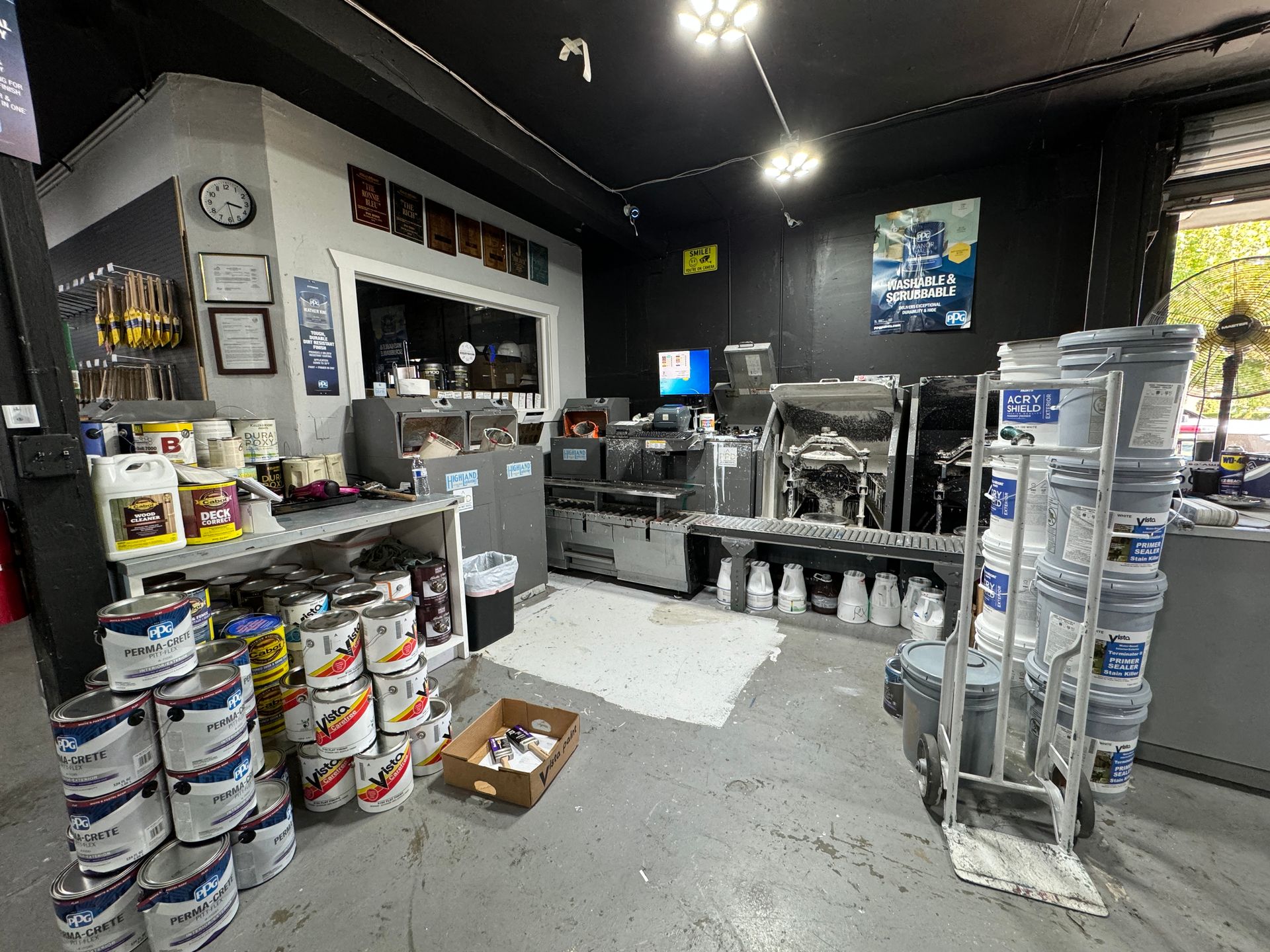 A room filled with lots of buckets of paint.