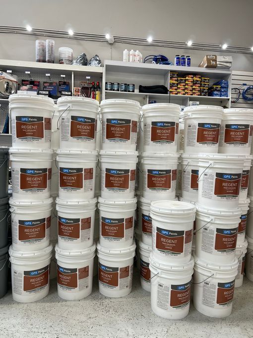 The back of a truck is filled with buckets of water.