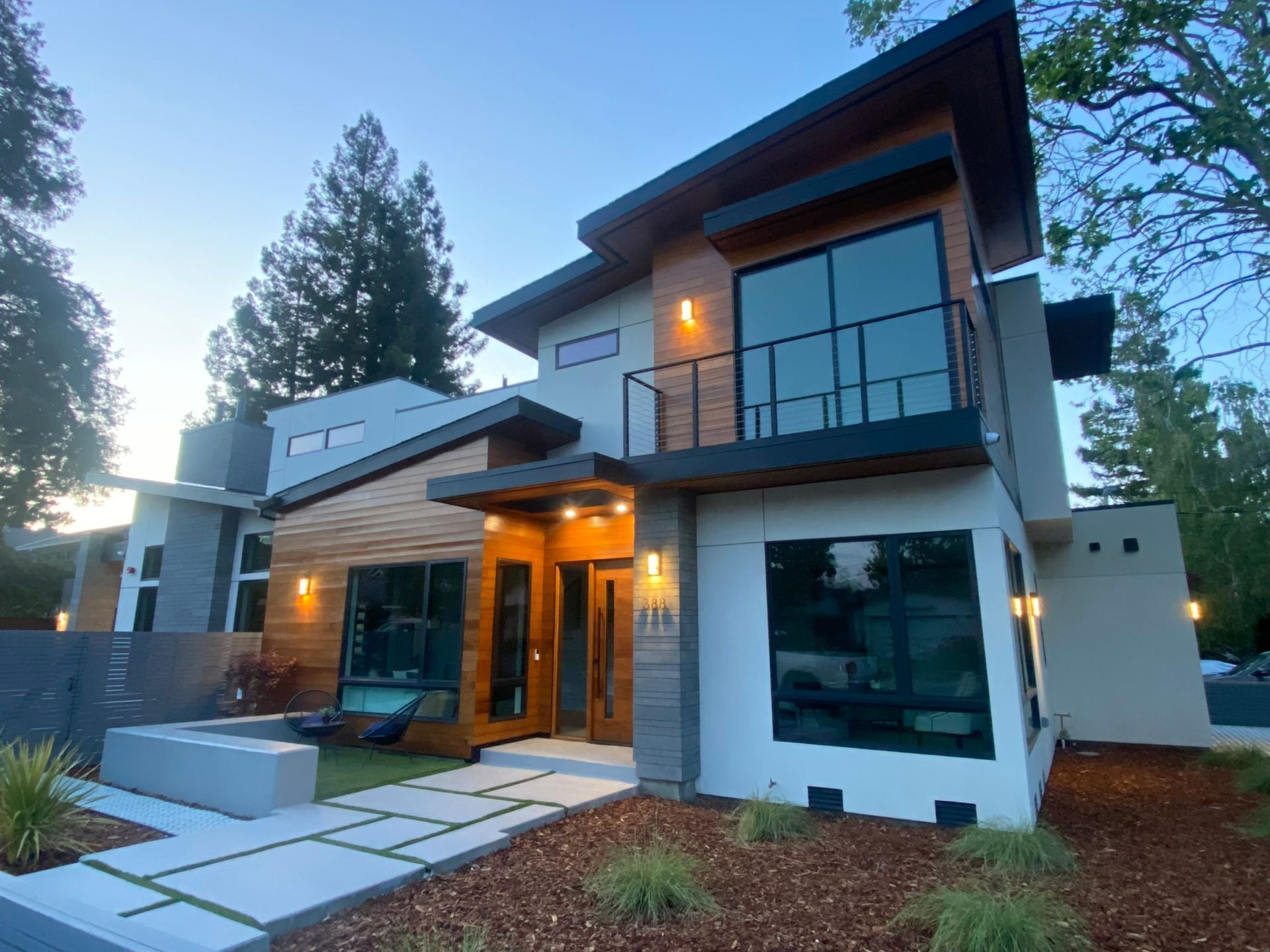A modern house with a lot of windows and a balcony