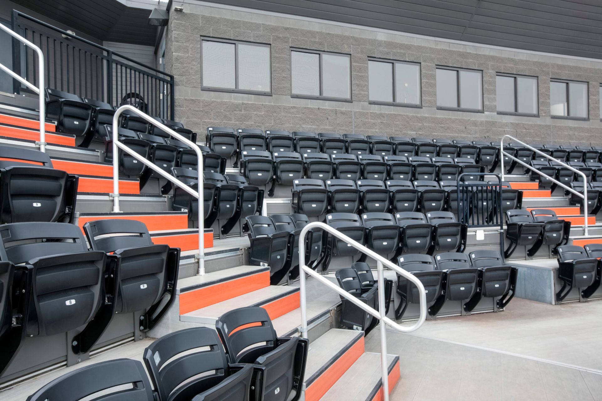 Black Interkal AURA Slat Stadium chairs in the bullpen area at the Brother Rice Warrior Park, in Michigan.