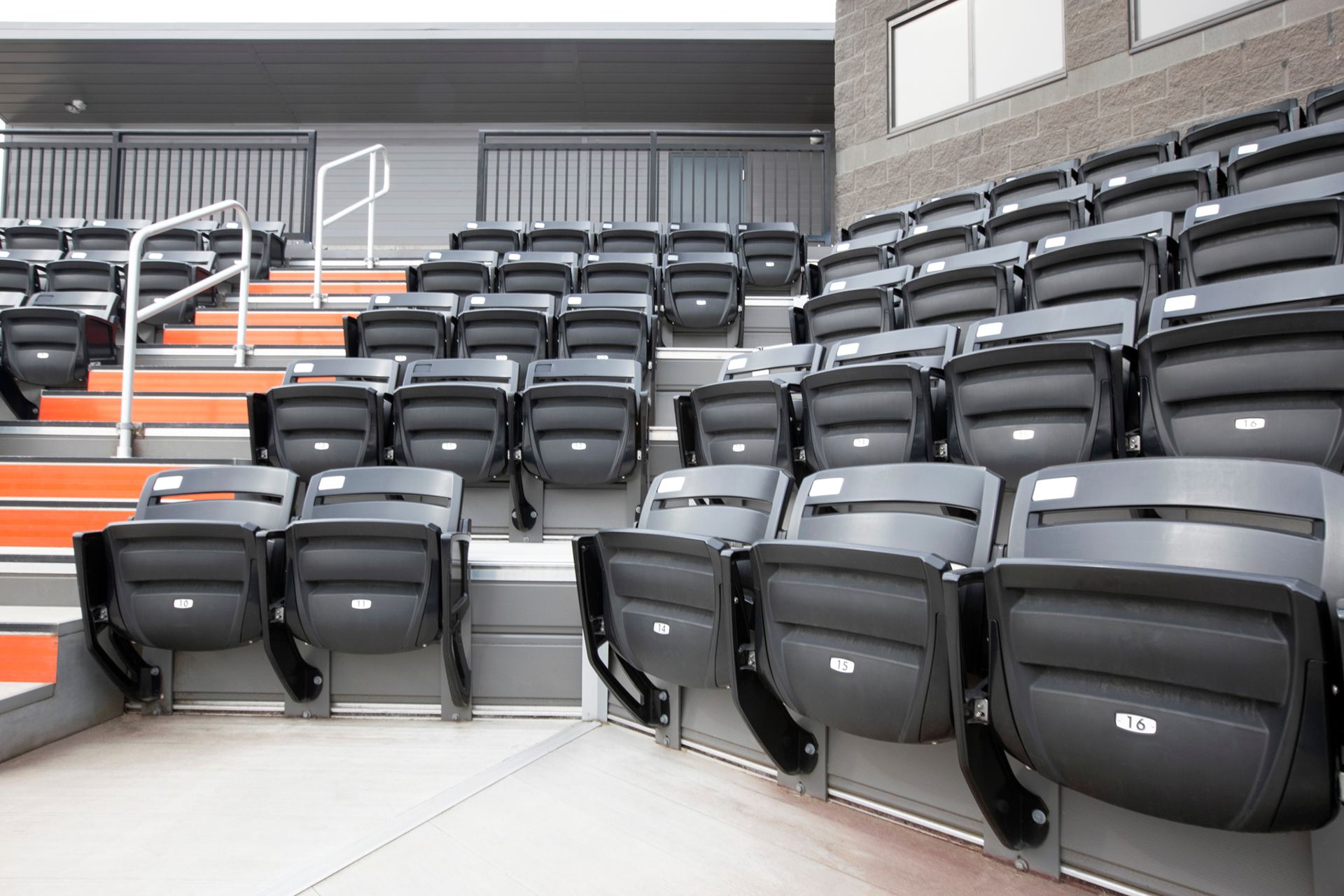 Black Interkal AURA Slat Stadium chairs in the bullpen area at the Brother Rice Warrior Park, in Michigan.