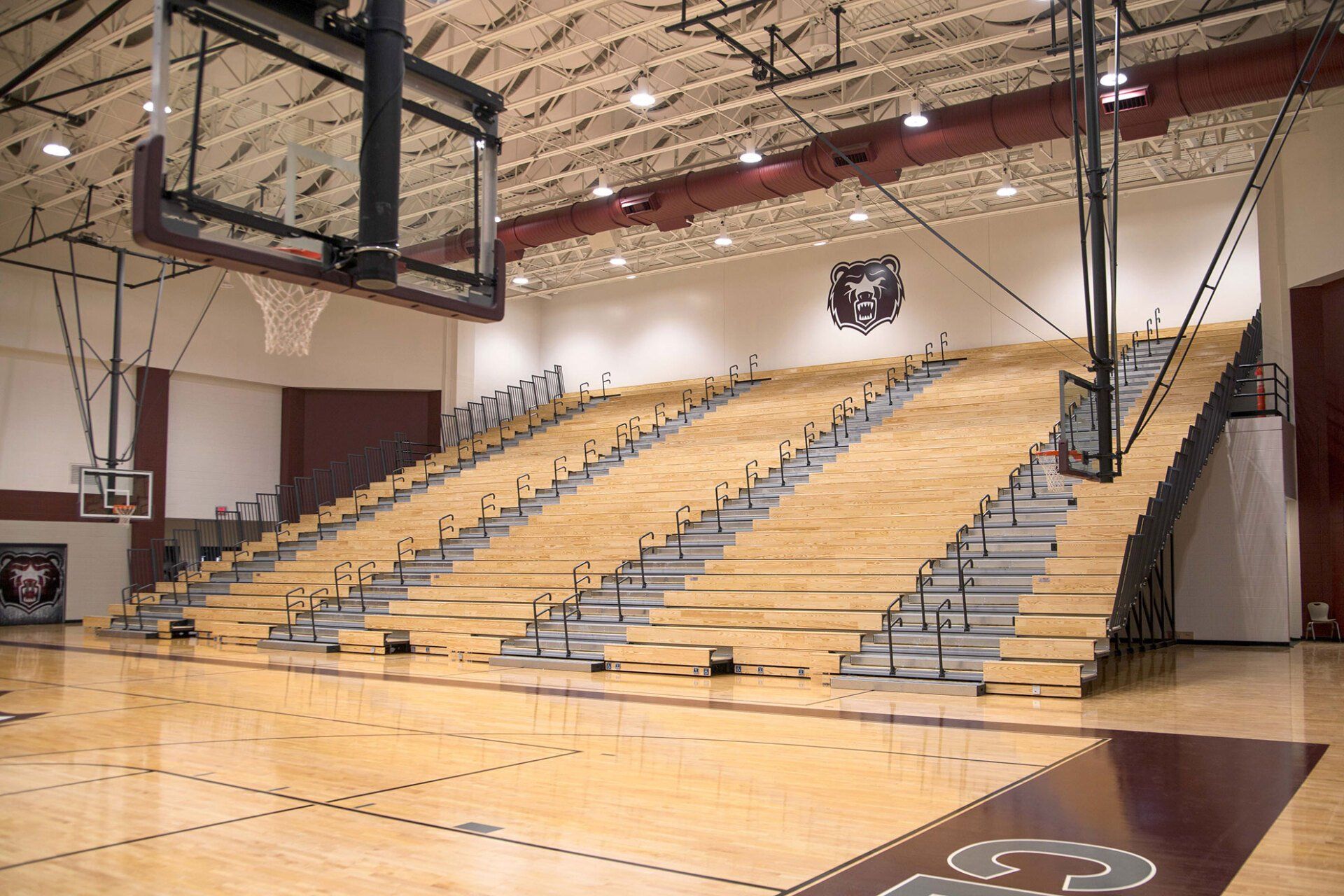 Classic Wood Bleachers with Self-Storing Aisle Rails (SSAR) in the gymnasium at Lawrence Central High School in Indiana.