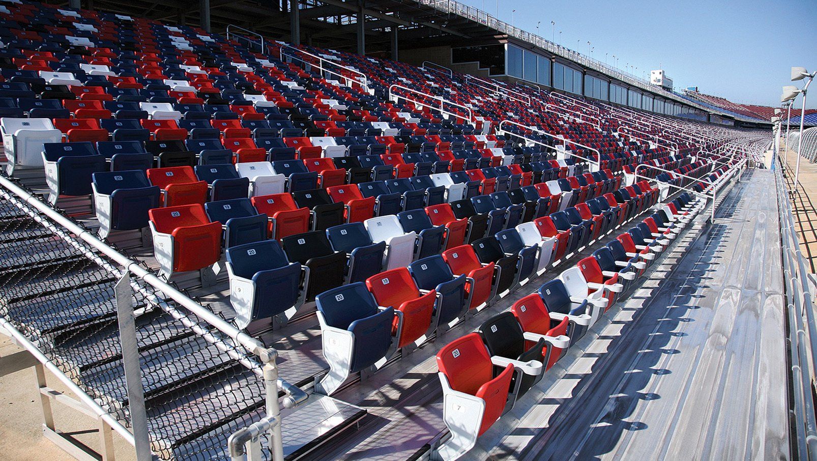 Interkal AURA Solid Stadium Chairs in red, white, blue and black at the iconic Talladega Superspeedway.
