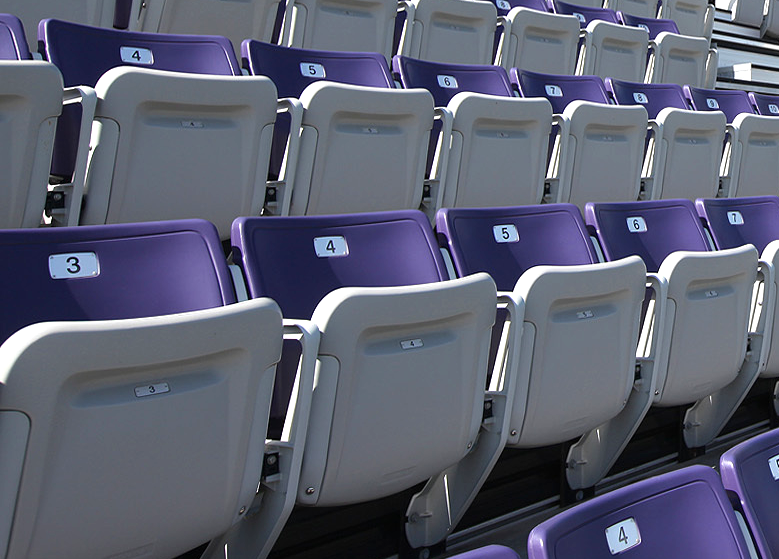 A multi-color use of purple and grey Interkal AURA Solid Stadium Chairs in the stadium at the University of Sioux Falls.