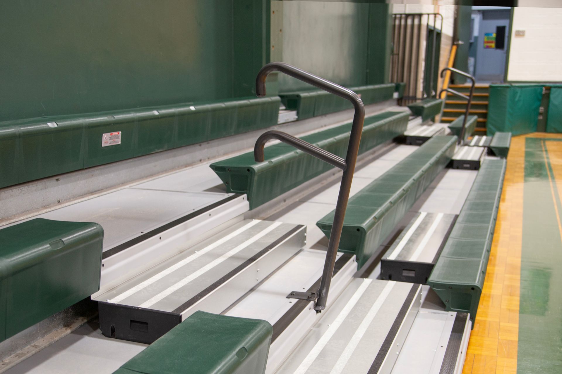 Renovated telescopic bleachers with EXCEL Seat Modules and Self-Storing Aisle Rails at the Holy Name Catholic School gym.