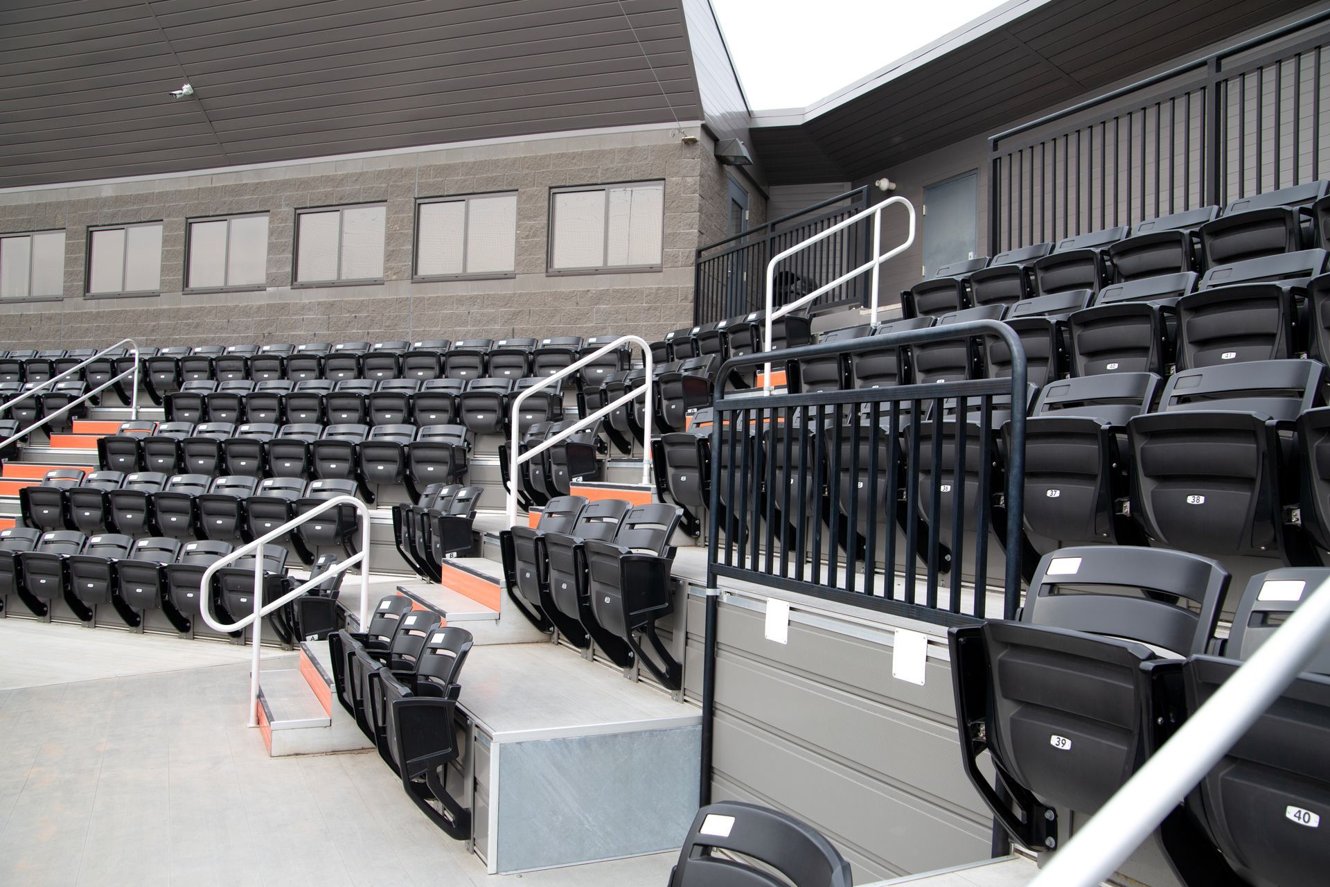 Black Interkal AURA Slat Stadium chairs in the bullpen area at the Brother Rice Warrior Park, in Michigan.