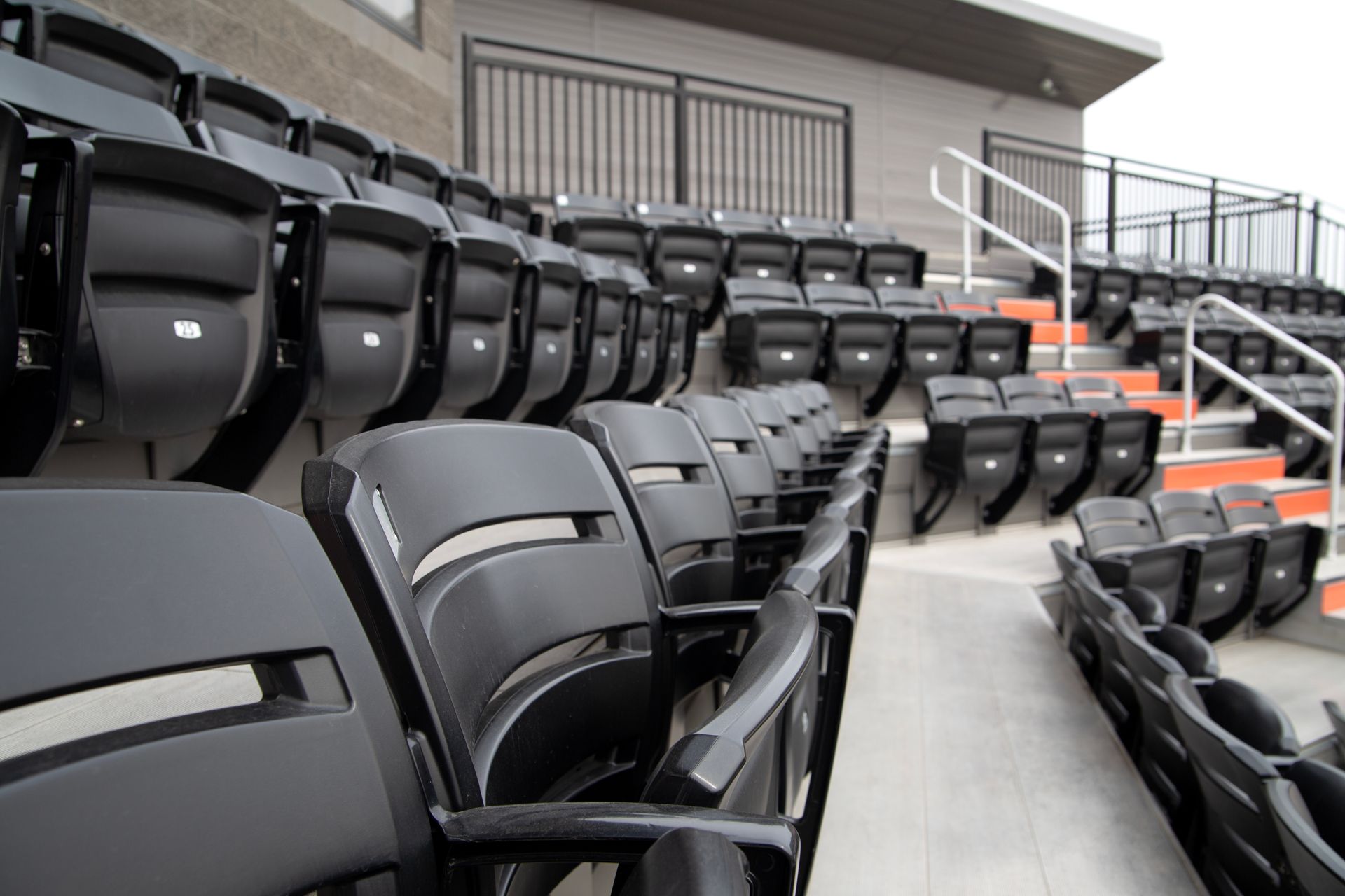 Black Interkal AURA Slat Stadium chairs in the bullpen area at the Brother Rice Warrior Park, in Michigan.
