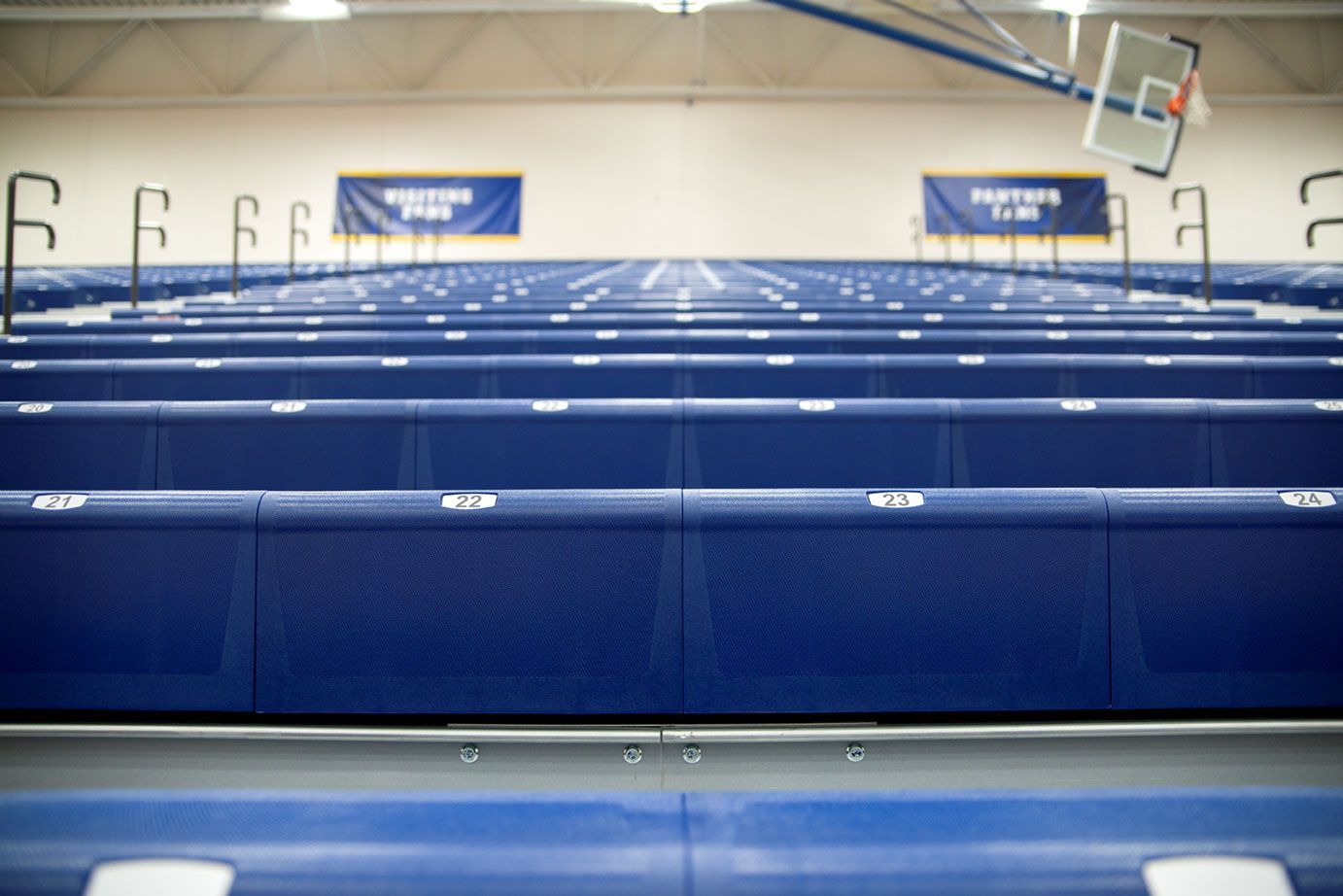 Blue Interkal EXCEL Seat Modules color the massive high-rise telescopic bleacher installation at the Dewitt High School gym.
