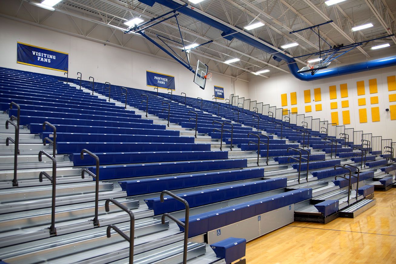 Blue Interkal EXCEL Seat Modules color the massive high-rise telescopic bleacher installation at the Dewitt High School gym.