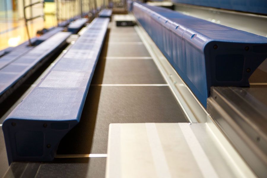 The gymnasium at Gull Lake Middle School, featuring Blackout B1 tier with blue EXCEL seat modules, self-storing aisle rails.