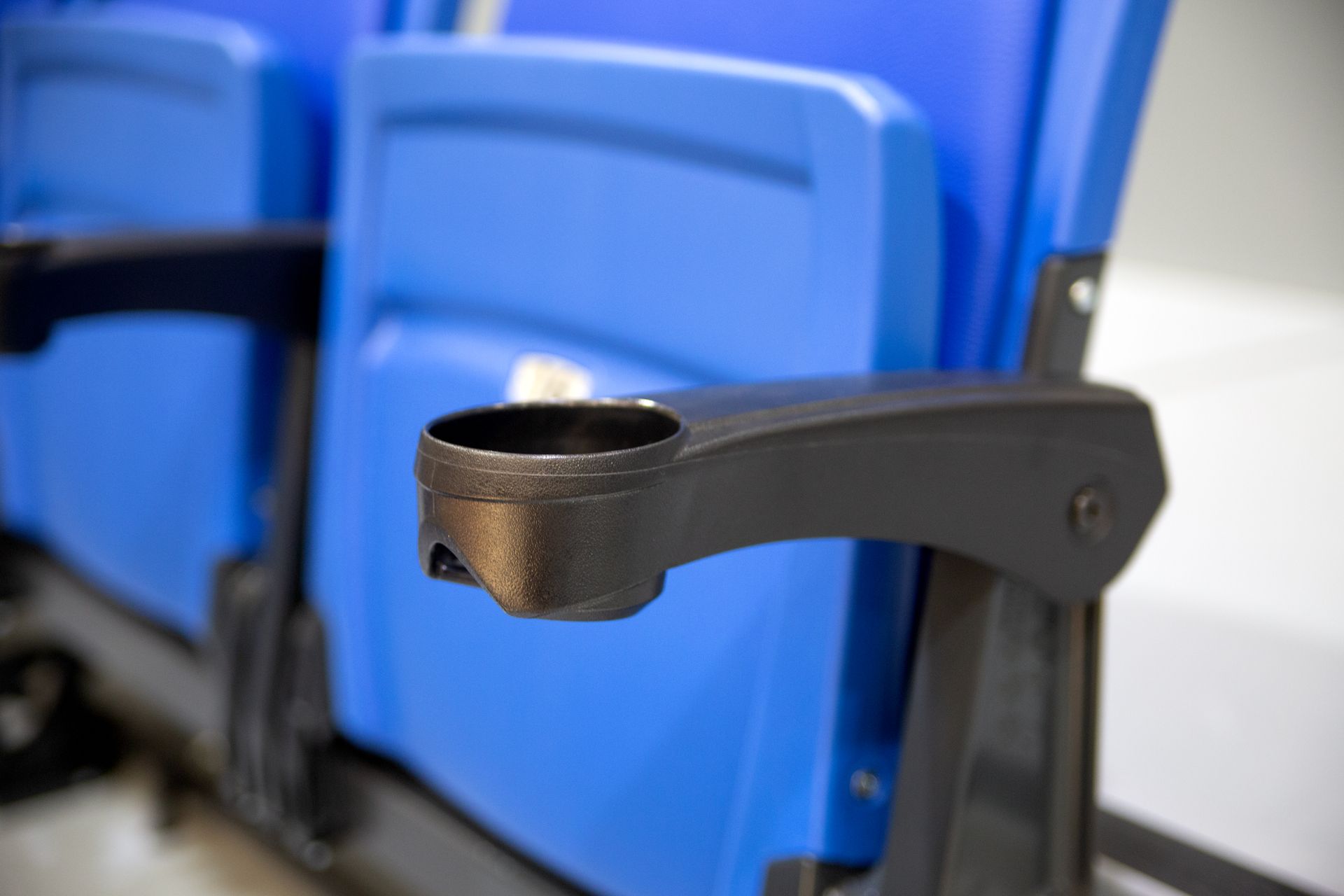 A close up of the cupholders on a Royal Blue VISION Platform Chair at Grand Valley State University