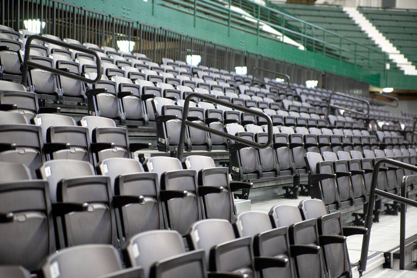 VISION Platform Chairs with armrests on a mobile Wide Deck Premier Platform system at Michigan State's Jenison Field House.