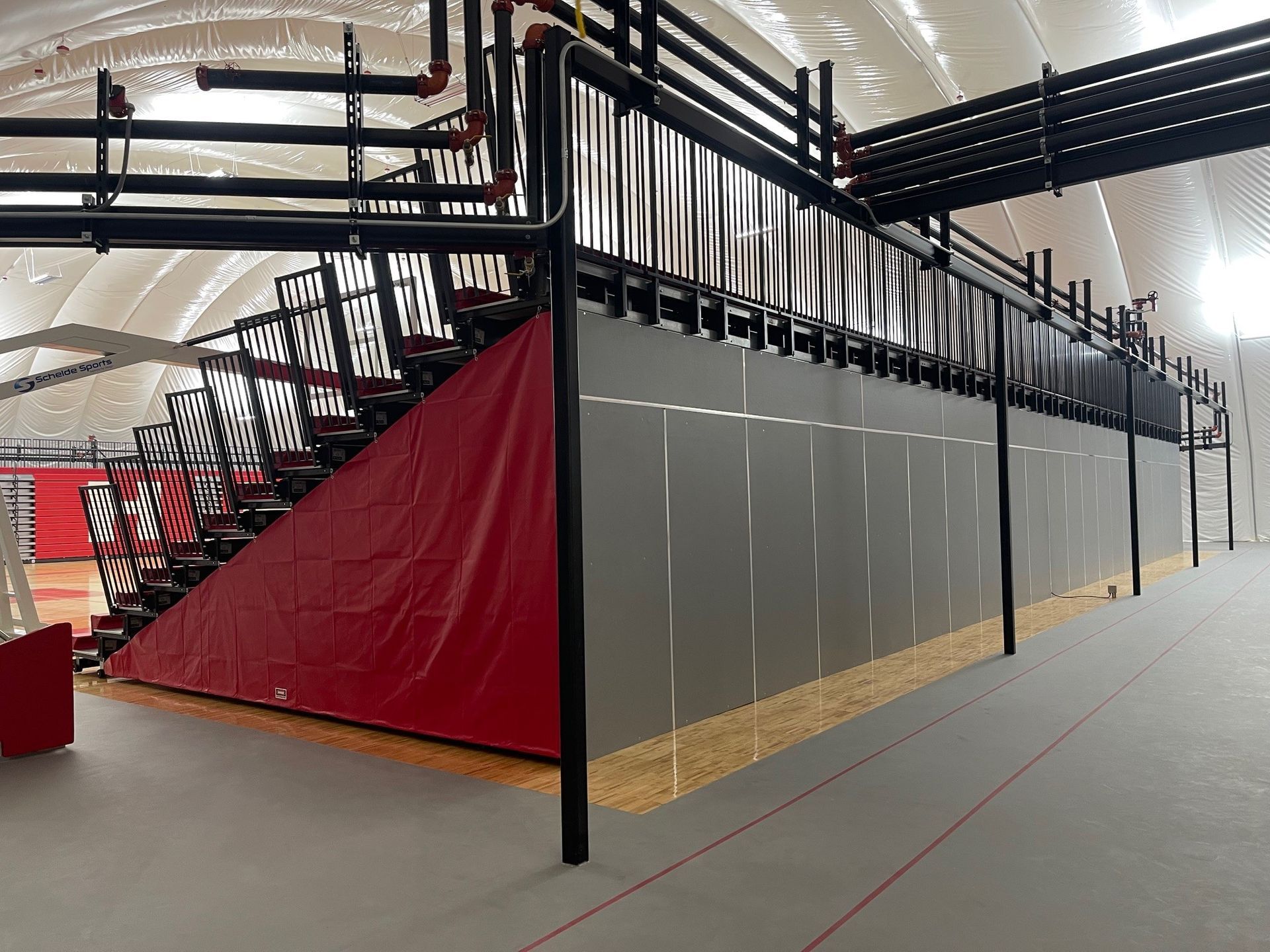 The telescopic bleacher system at the Melvindale High School dome, in Michigan, which features white school initials.