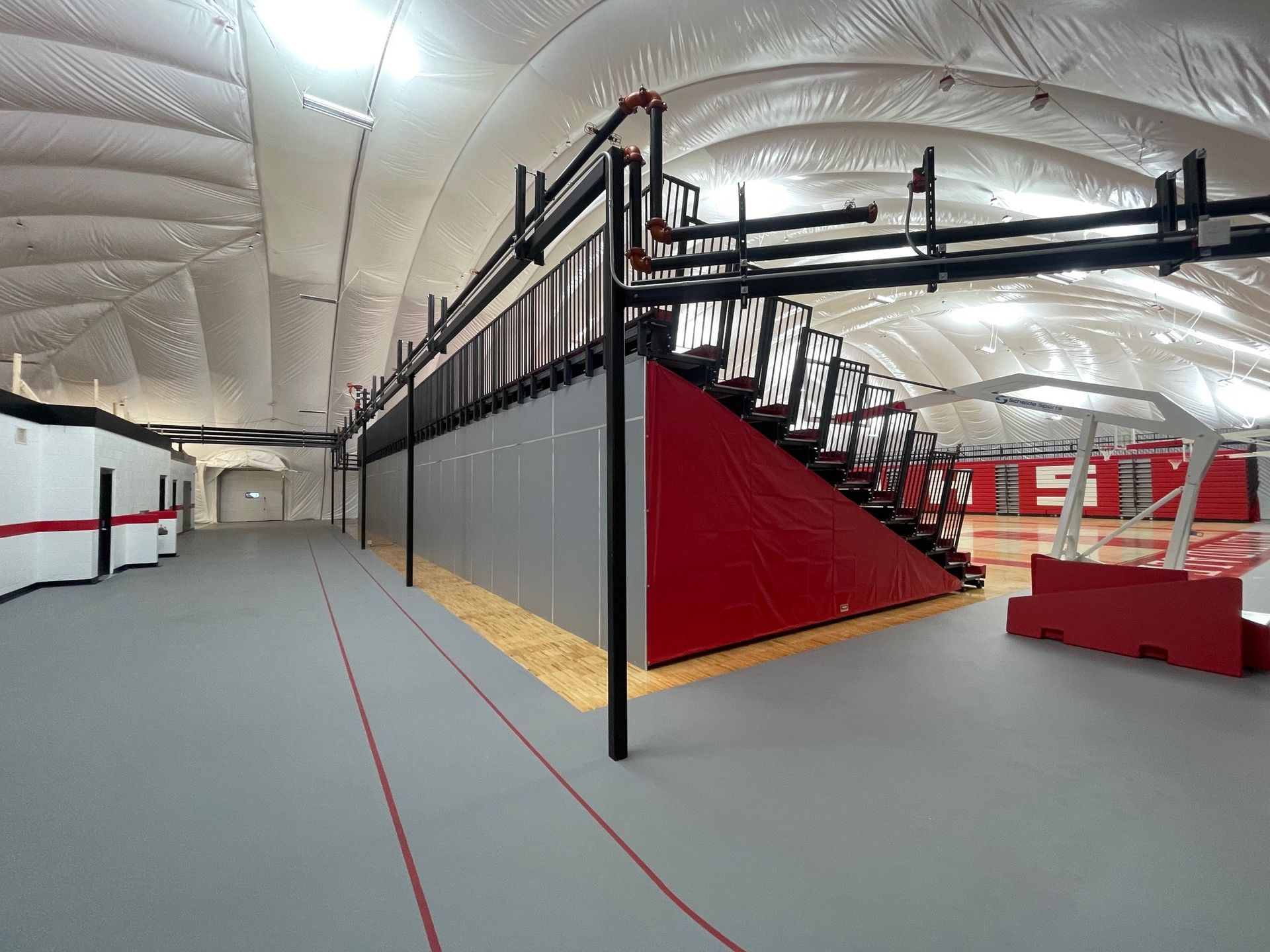 The telescopic bleacher system at the Melvindale High School dome, in Michigan, which features white school initials.