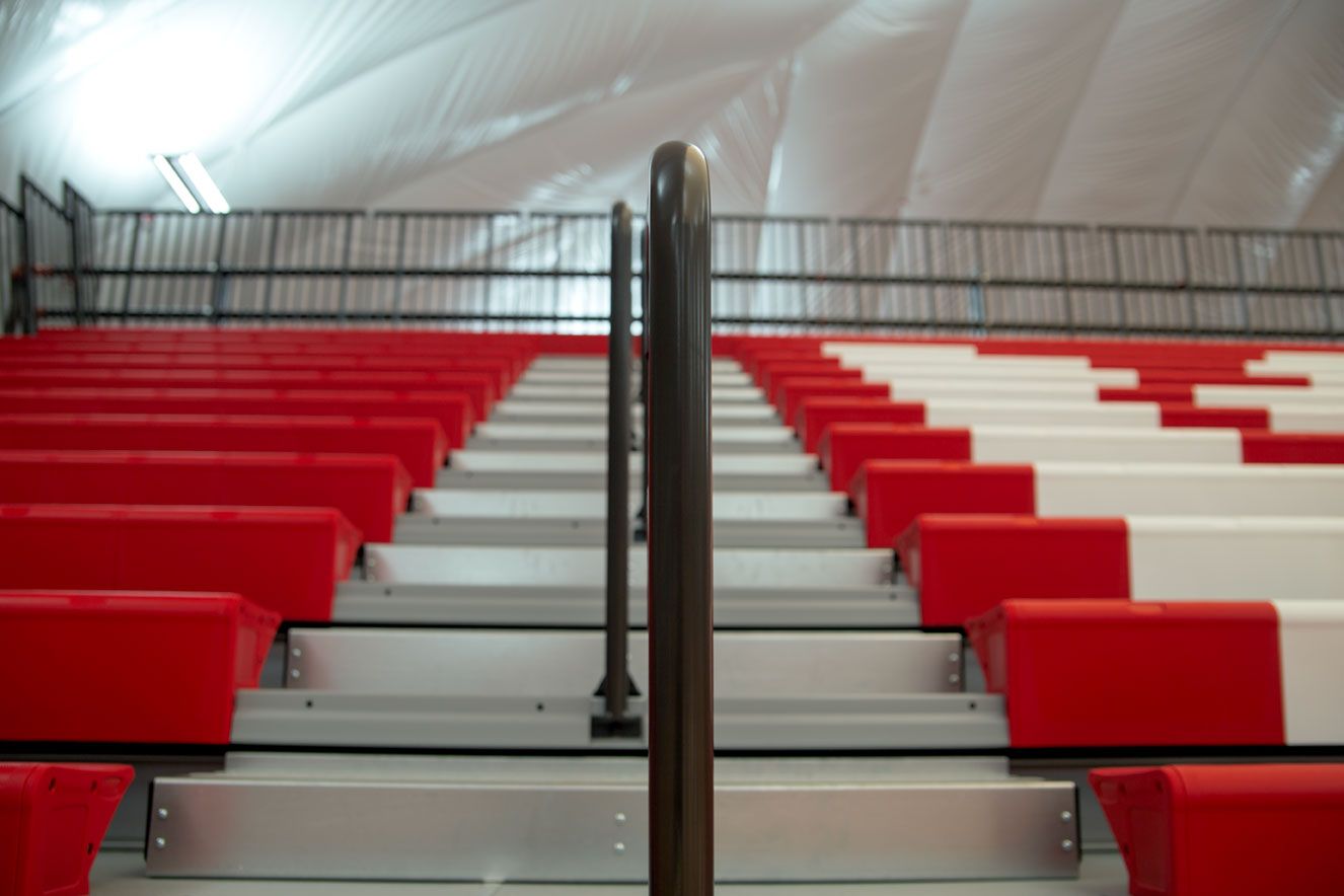 The telescopic bleacher system at the Melvindale High School dome, in Michigan, which features white school initials.