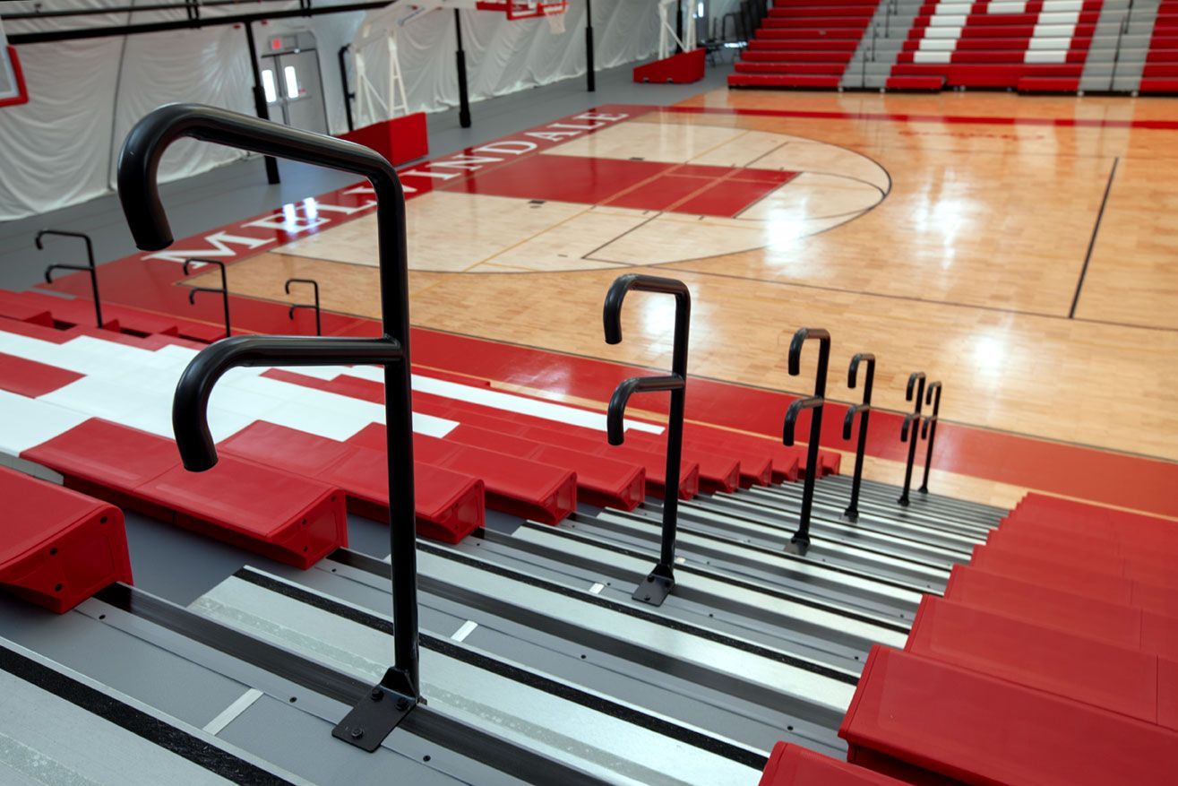 The telescopic bleacher system at the Melvindale High School dome, in Michigan, which features white school initials.