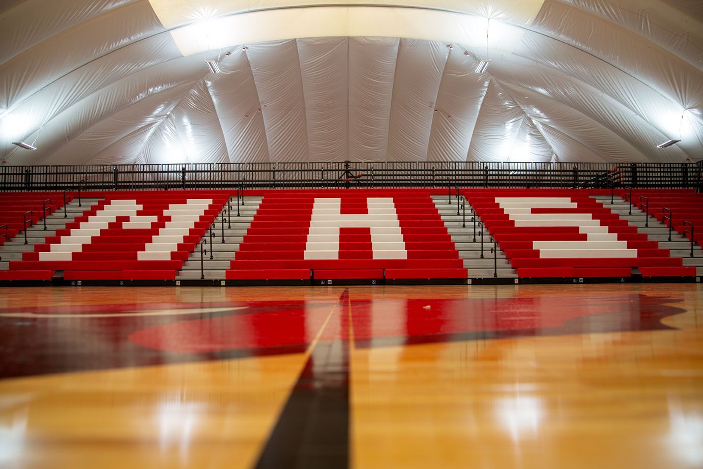 The telescopic bleacher system at the Melvindale High School dome, in Michigan, which features white school initials.