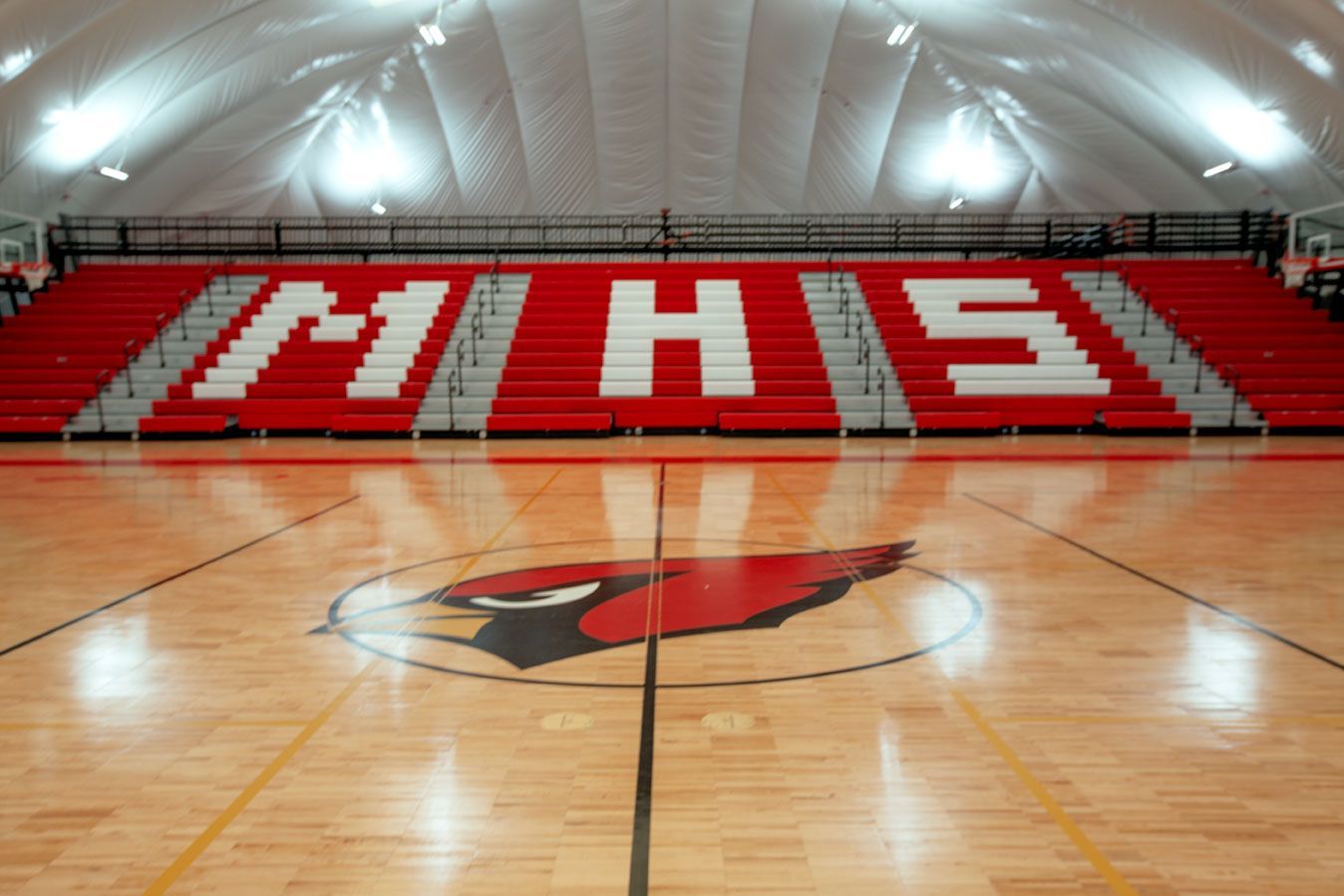 The telescopic bleacher system at the Melvindale High School dome, in Michigan, which features white school initials.