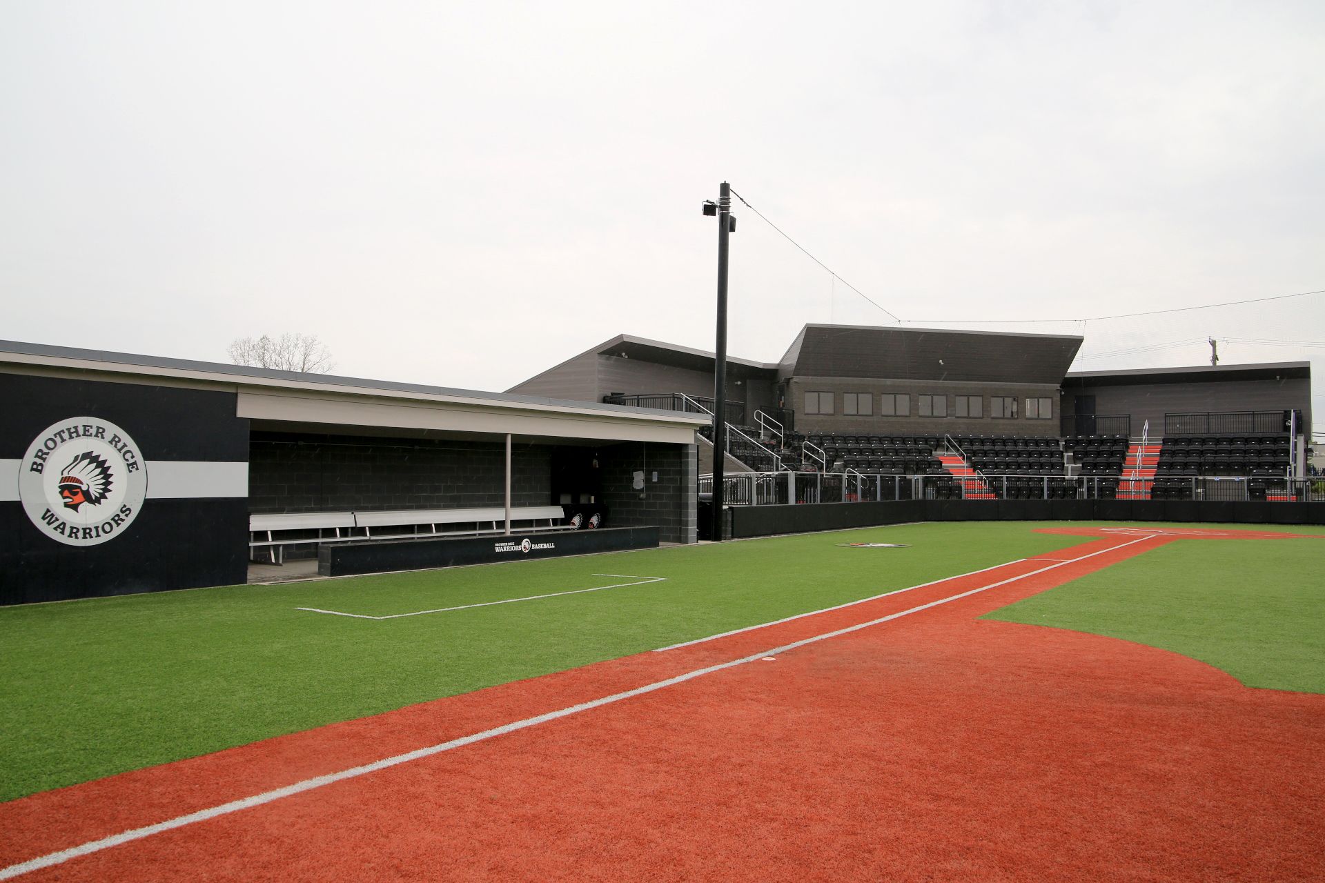 Black Interkal AURA Slat Stadium chairs in the bullpen area at the Brother Rice Warrior Park, in Michigan.