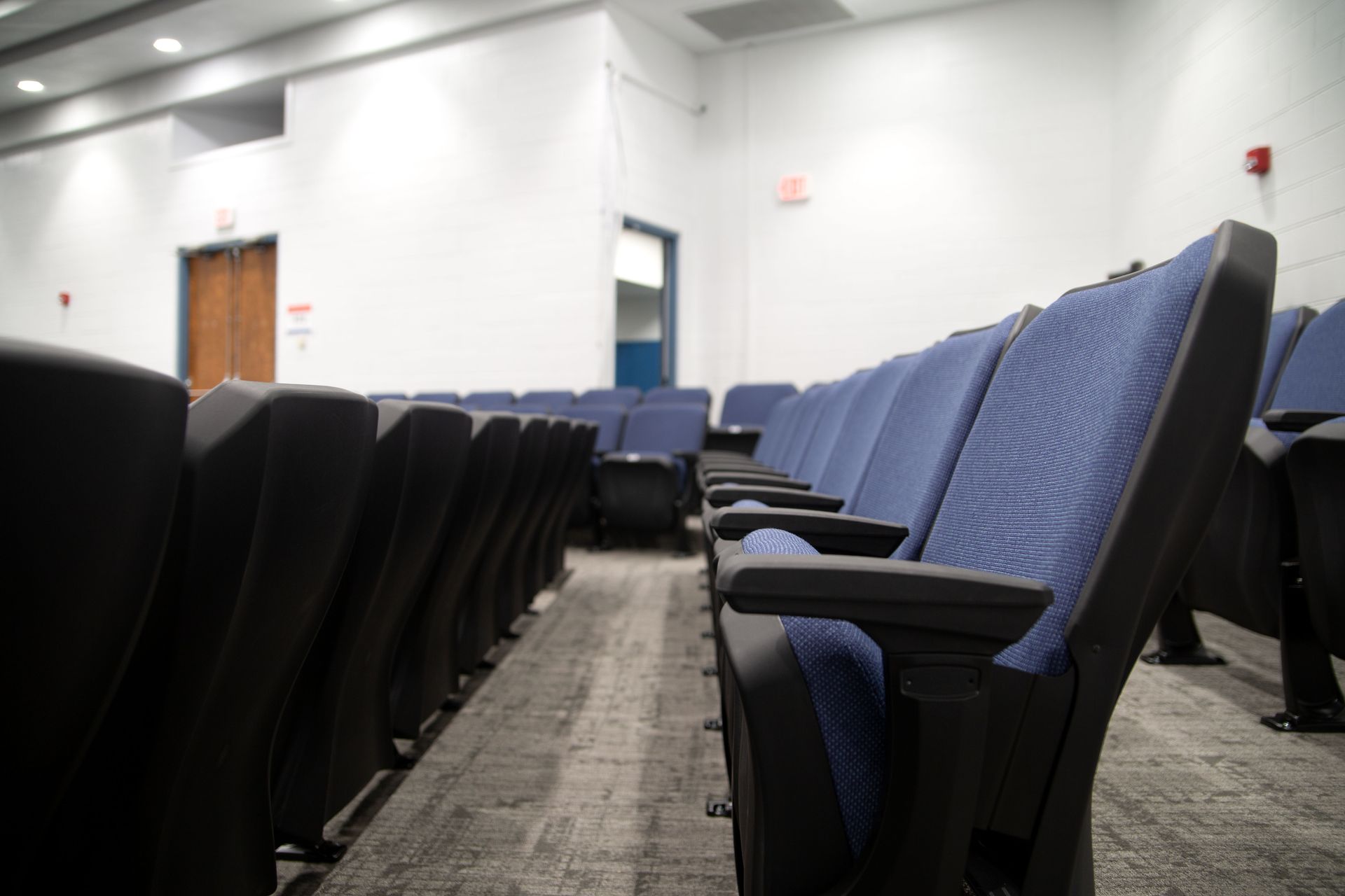 The auditorium at Sundling Junior High, with ODYSSEY Auditorium Chairs with molded armrests, blue upholstery, seat numbers. 