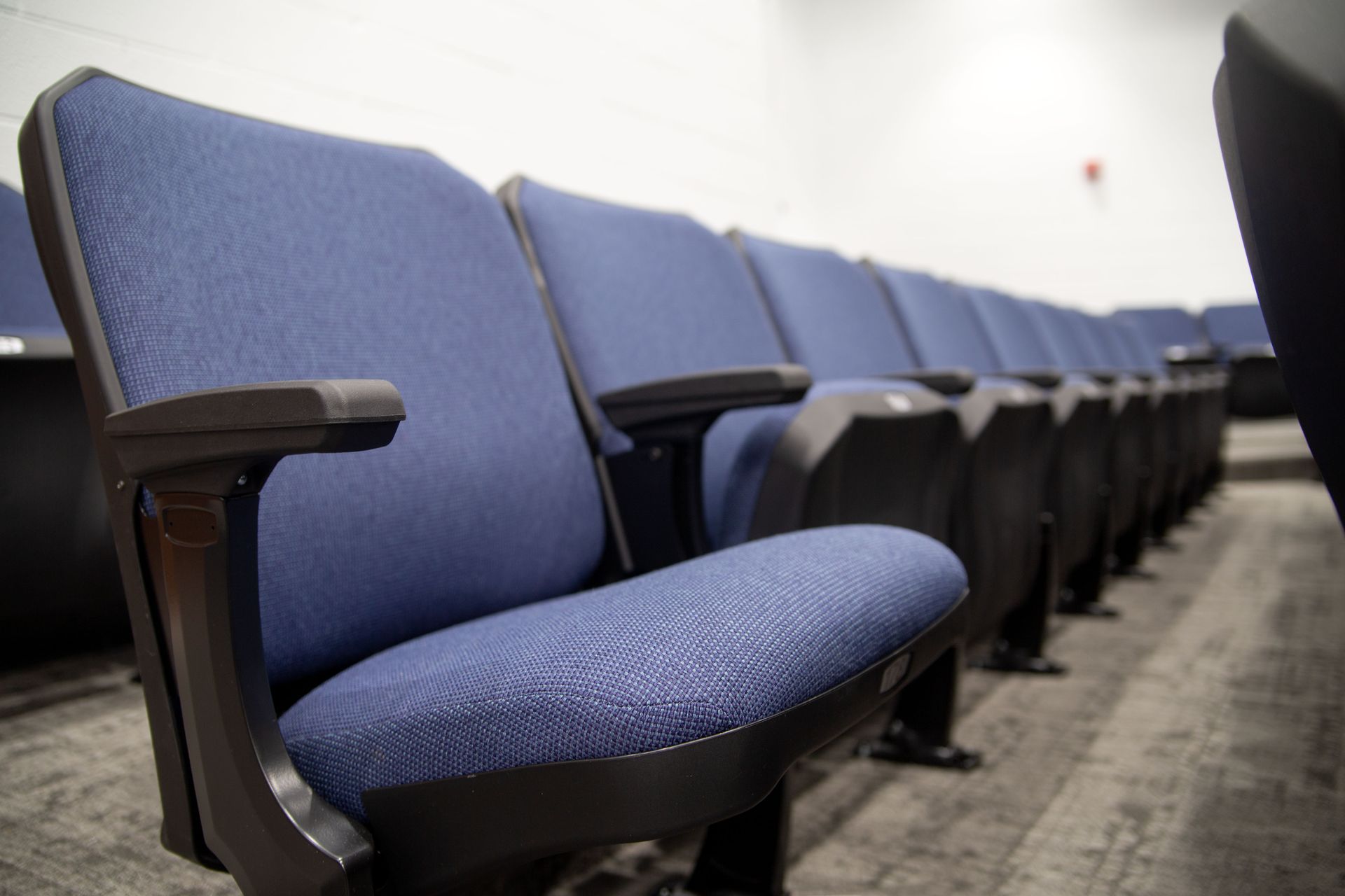 The auditorium at Sundling Junior High, with ODYSSEY Auditorium Chairs with molded armrests, blue upholstery, seat numbers. 
