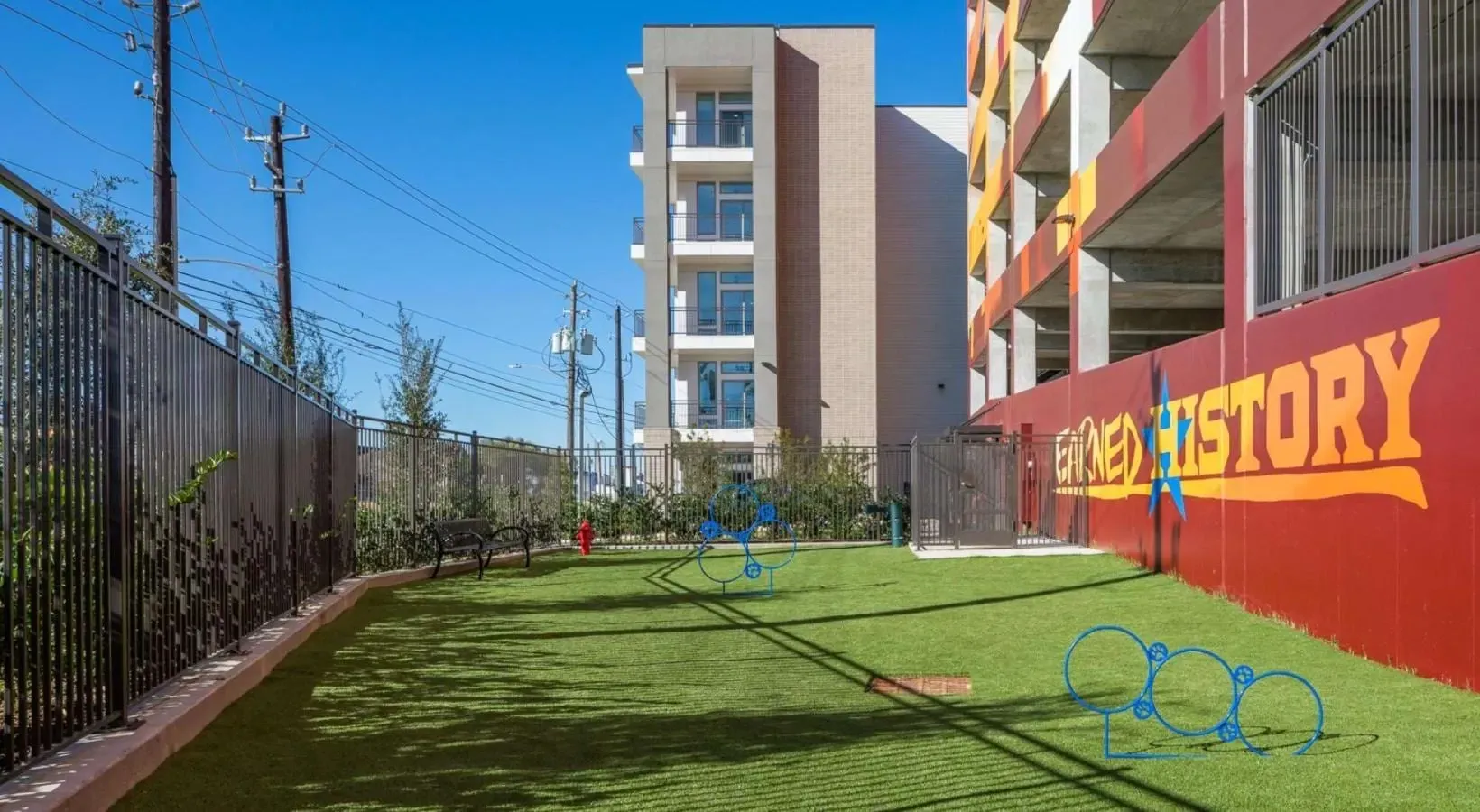 Apartment building with a dog park and artificial turf