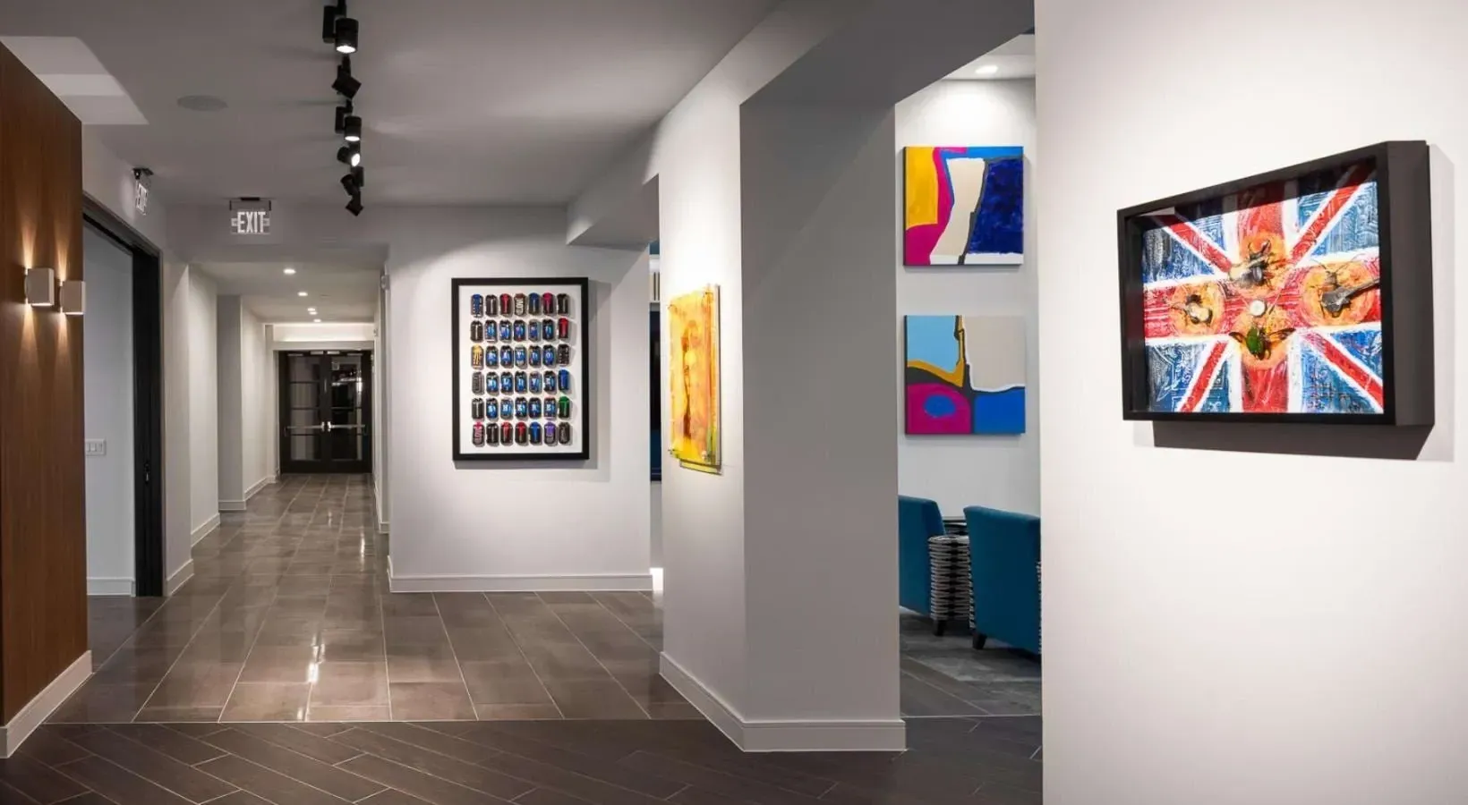 Hallway with modern art and seating areas.
