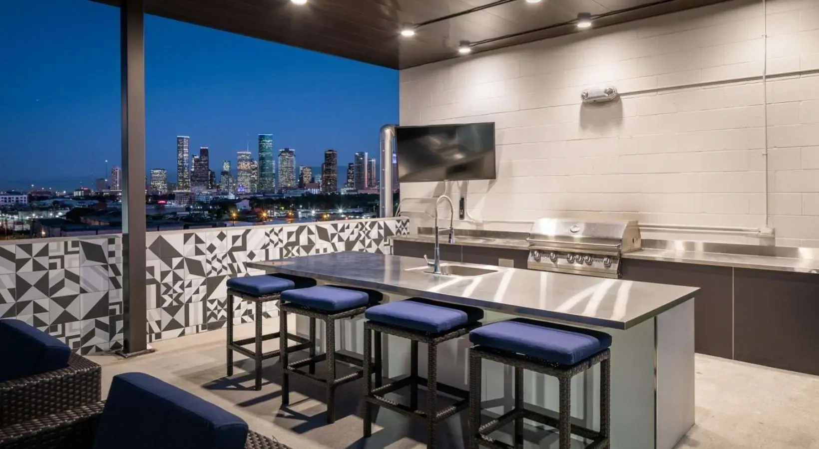 Rooftop outdoor kitchen with city skyline view