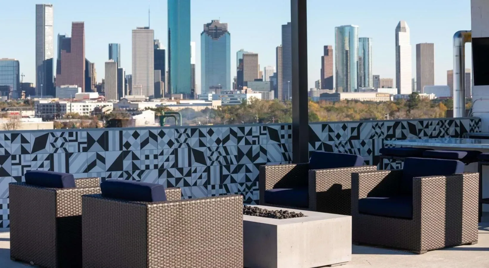 Outdoor lounge area with city skyline view