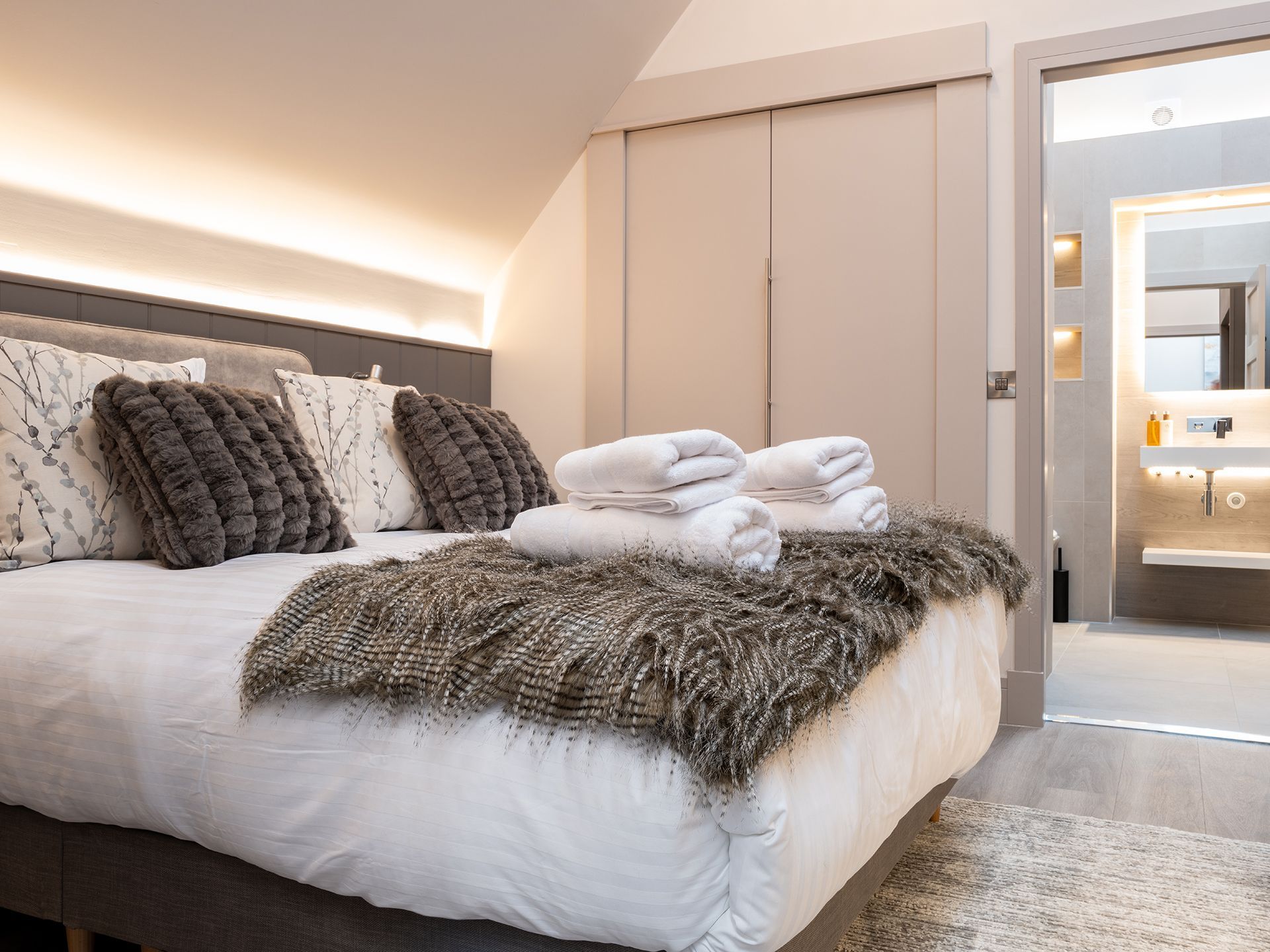 A bedroom with a king size bed and a bathroom.