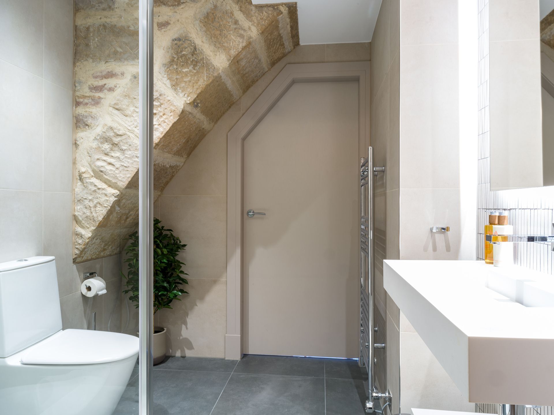 A bathroom with a toilet , sink and mirror