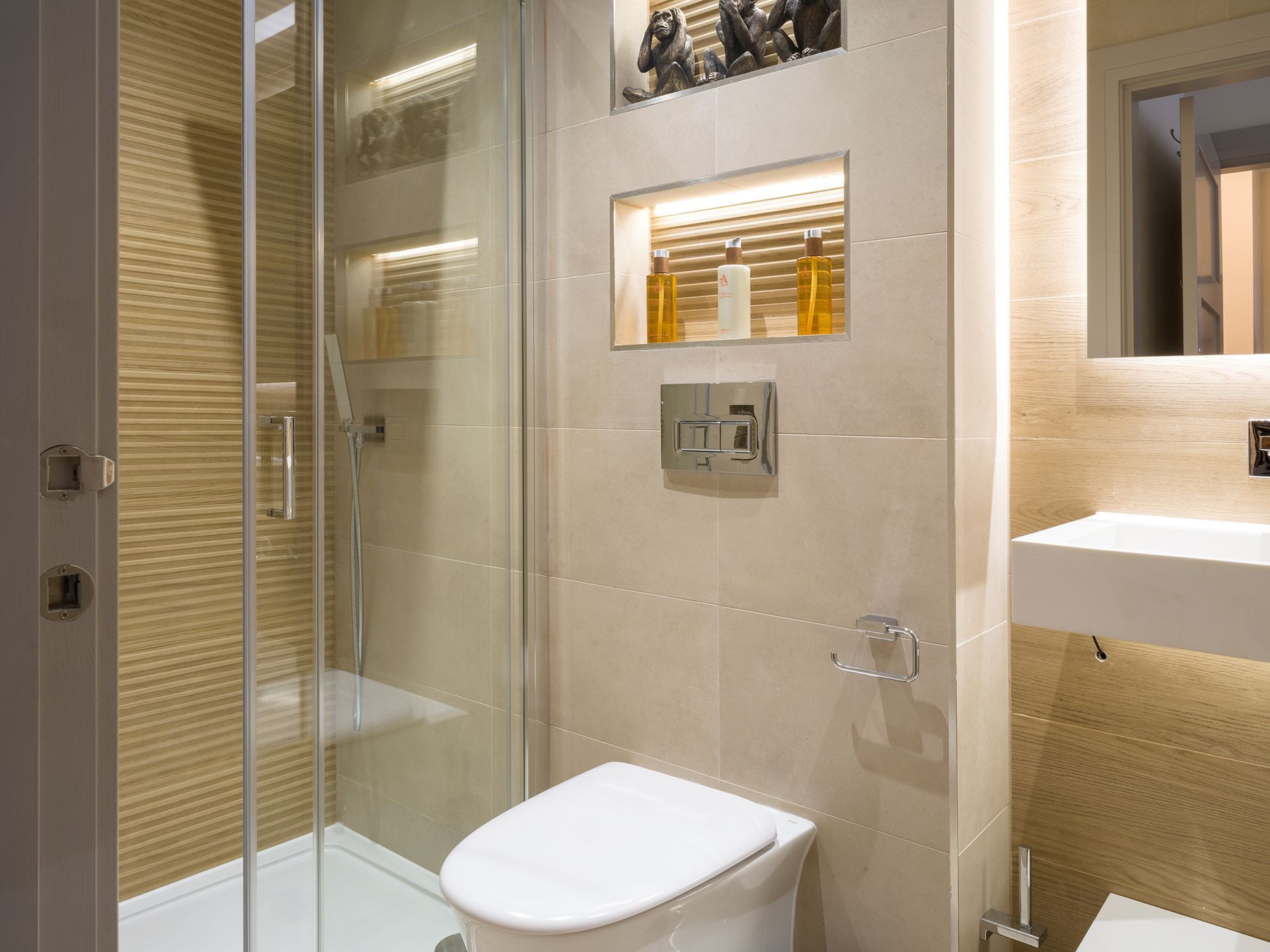 A bathroom with a toilet , sink and shower stall.