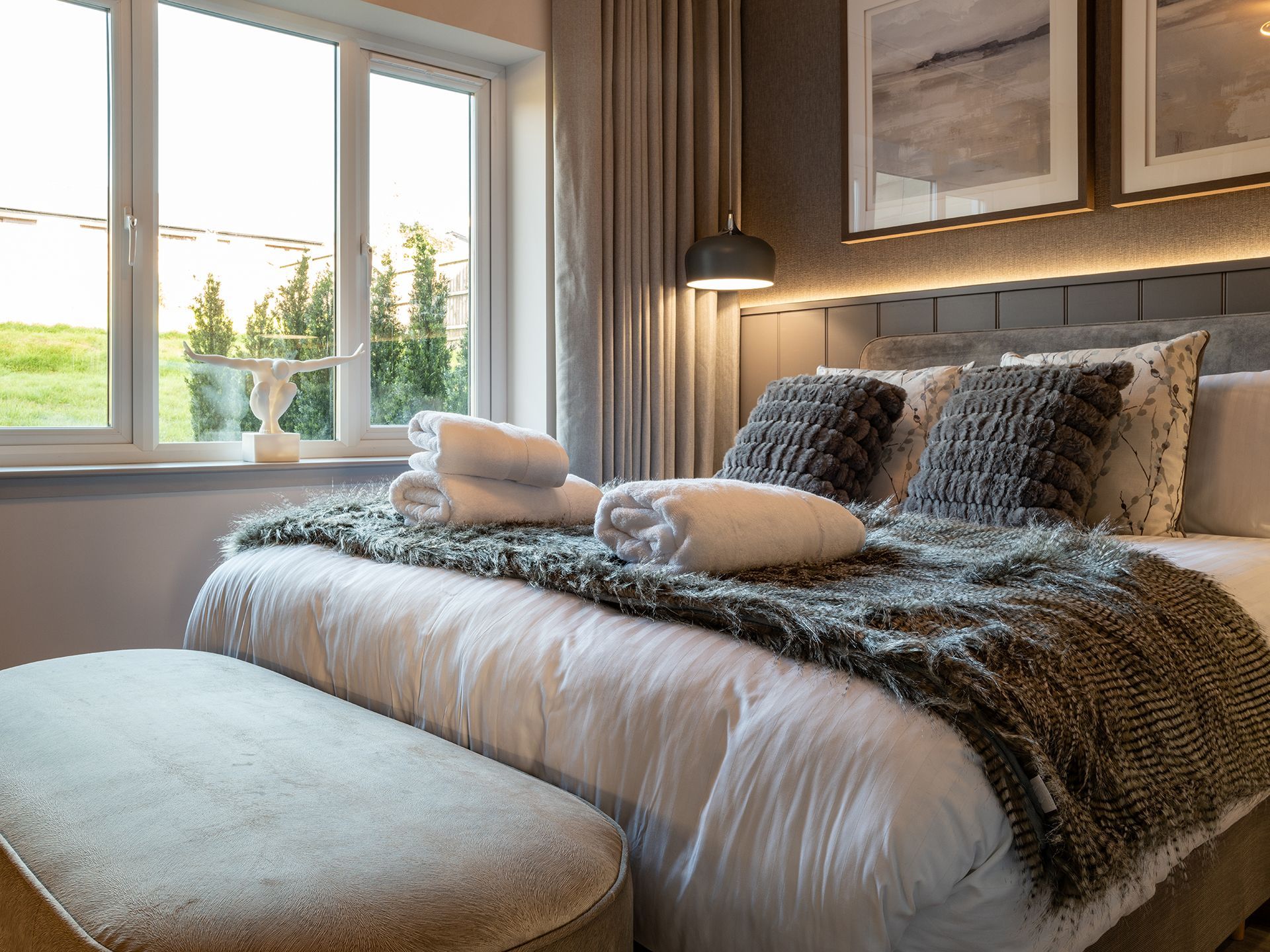 A bedroom with a large bed and a window.